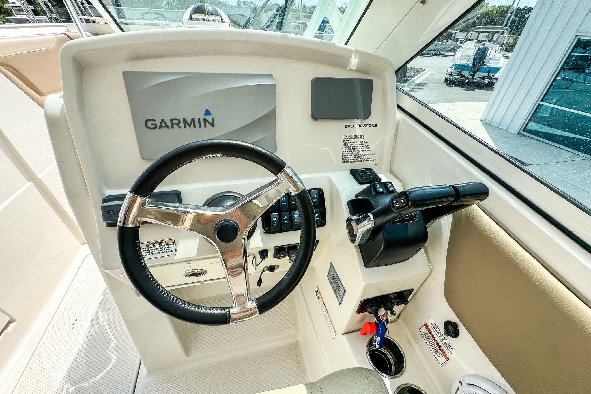 2018 Sailfish 275 DC boat helm with Garmin navigation system and steering wheel.