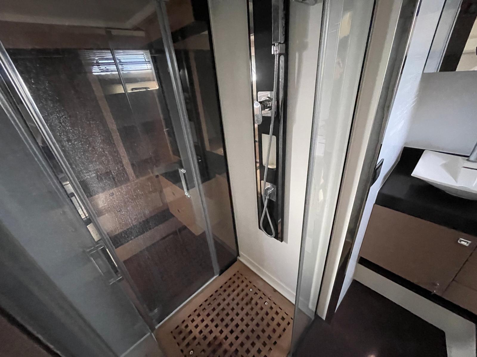 Modern shower area in a 2018 Prestige 560 yacht bathroom.