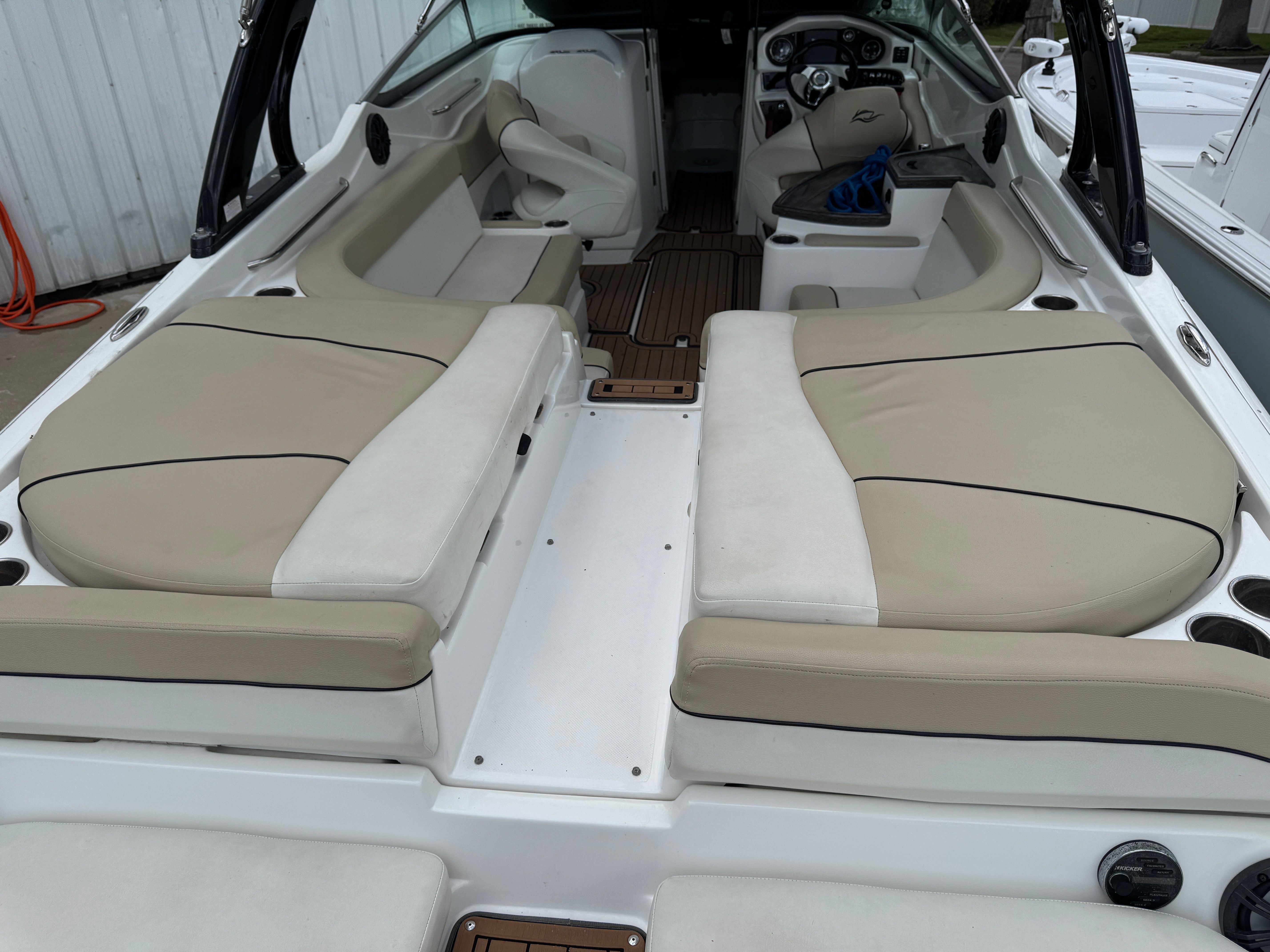 Interior of a 2017 Rinker QX29 BR boat with beige seating.