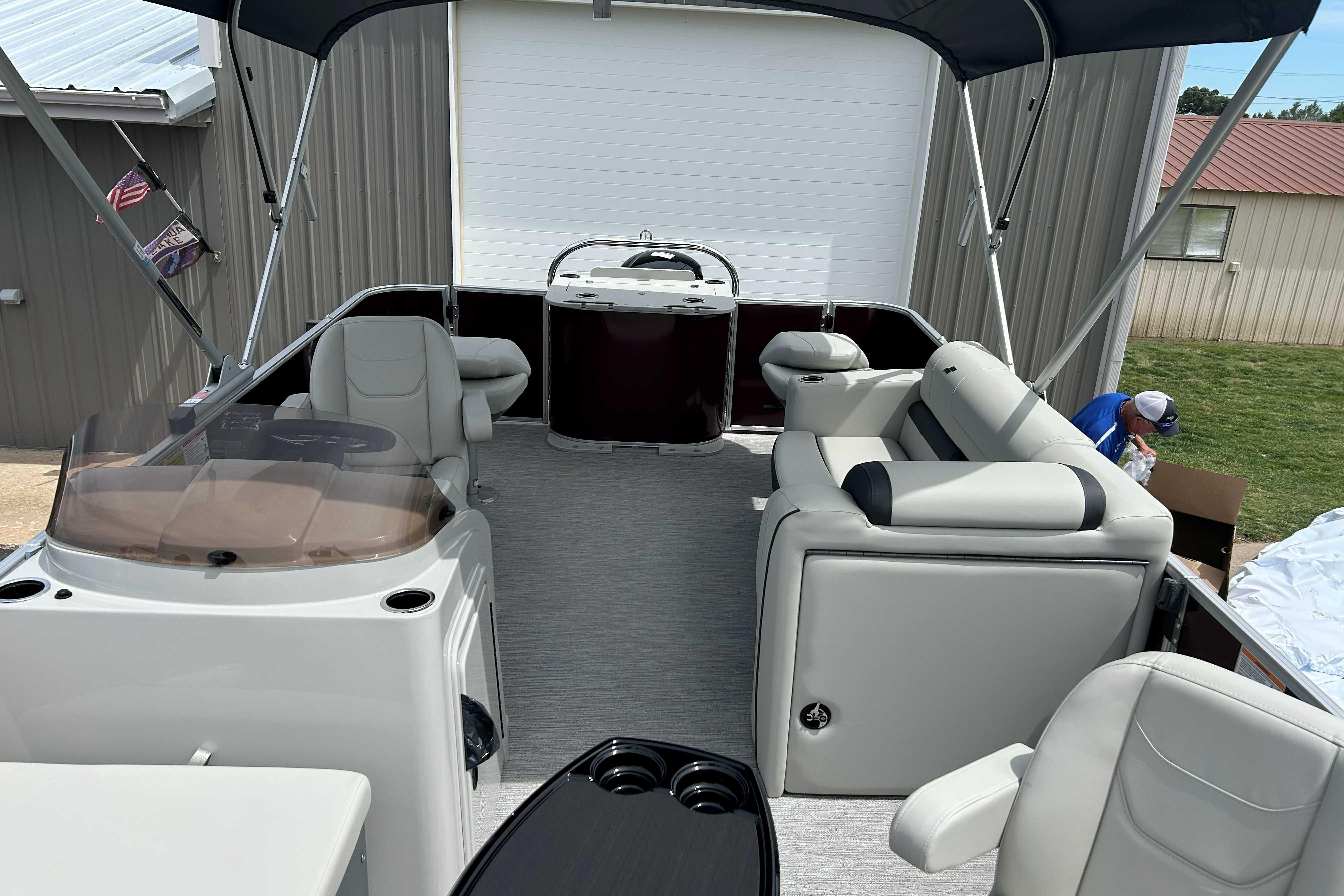 2026 Starcraft EX 20 F pontoon boat interior with seating and helm under canopy.