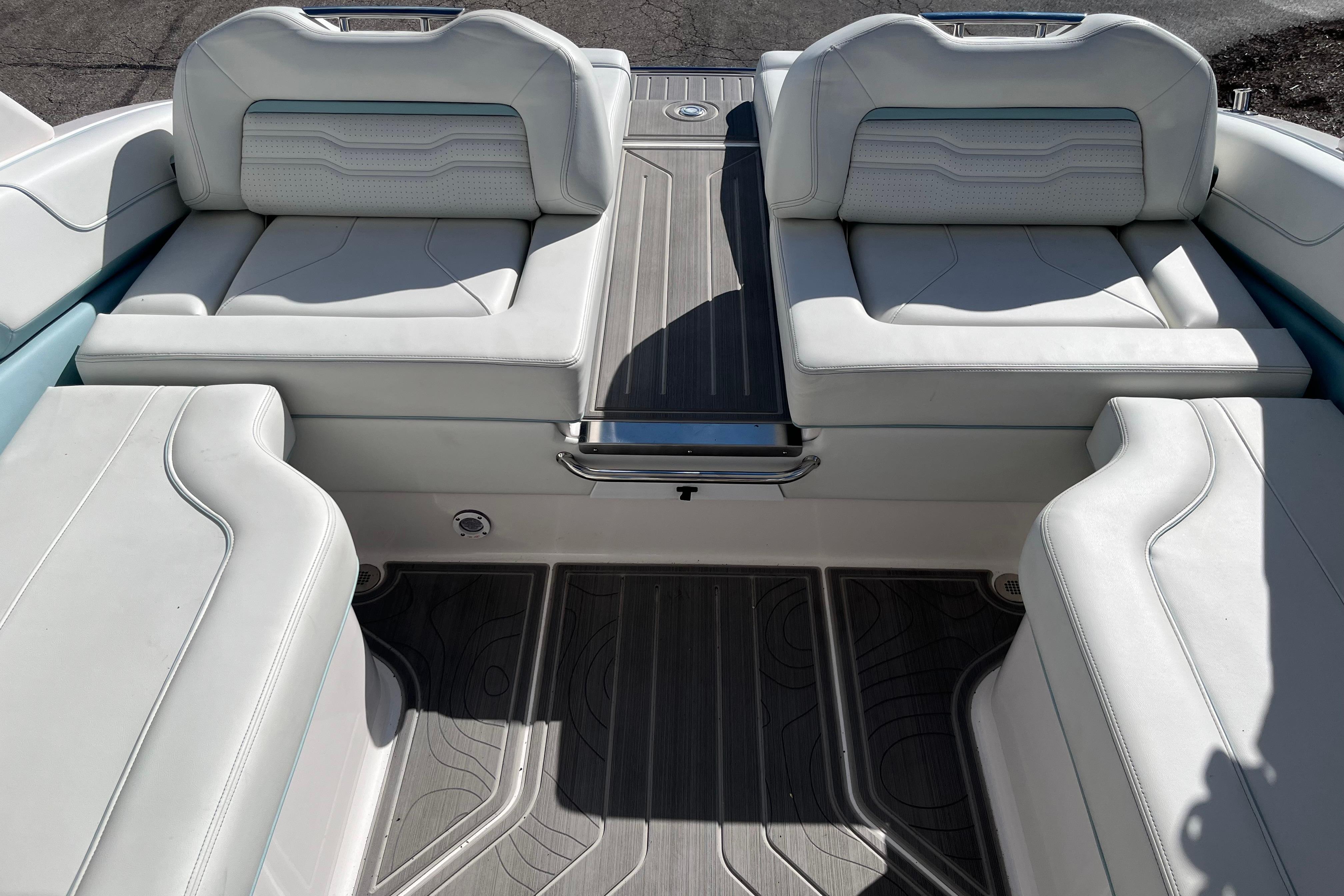 2024 Regal LS9 Surf boat interior with luxurious white seating and sleek flooring.