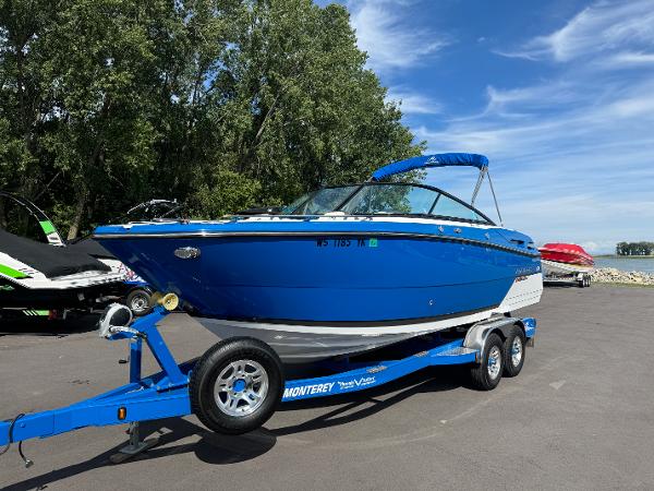 2018 Monterey 258 Super Sport boat on trailer, blue exterior, parked outdoors.