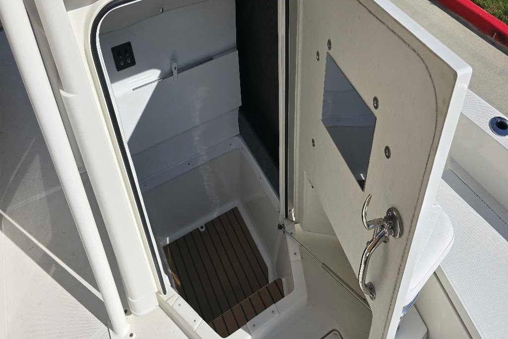 2025 Ranger 2360 Bay boat interior with open hatch and wooden flooring.
