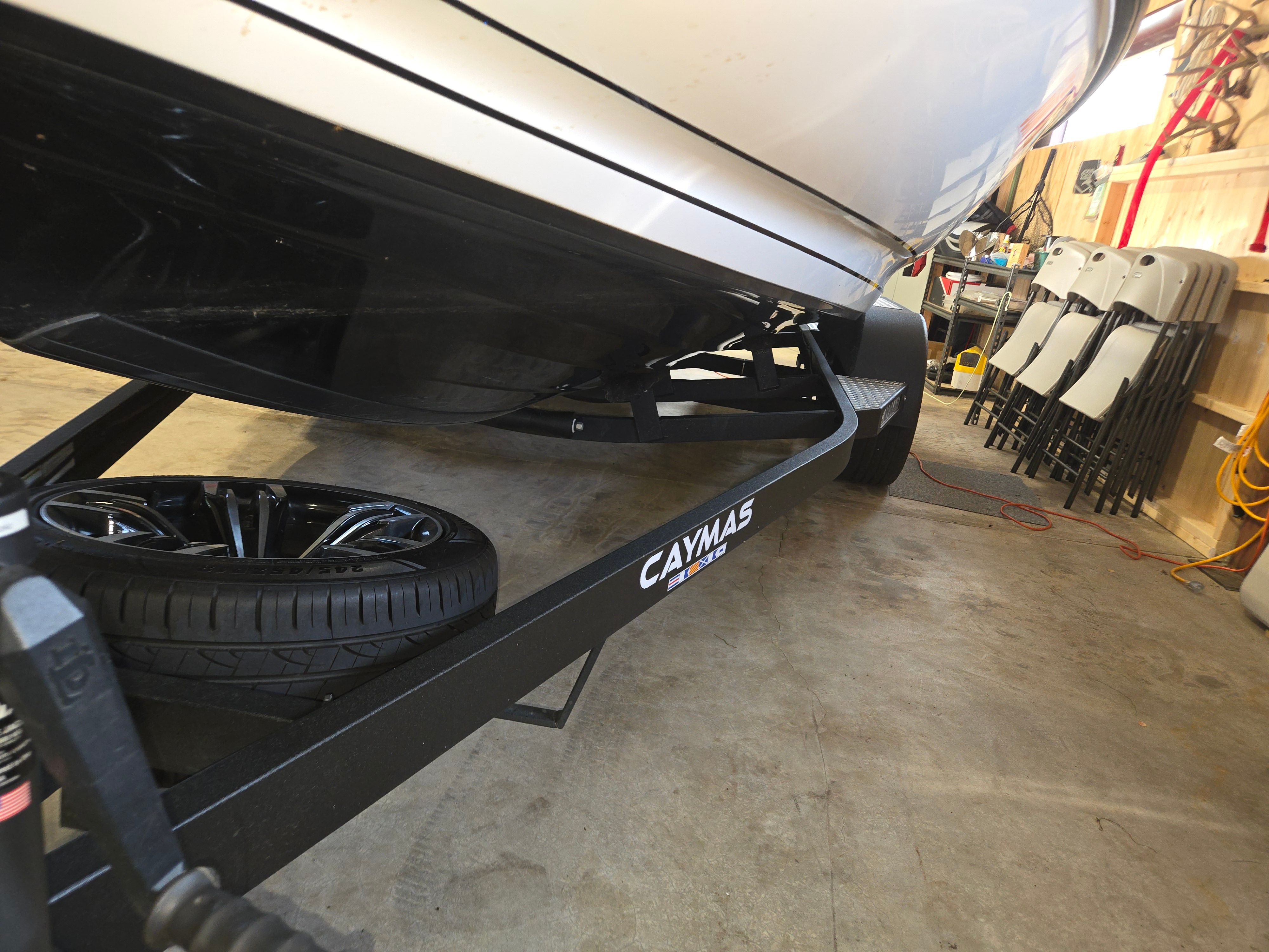 A 2022 Caymas CX 19 boat on a trailer in a garage.