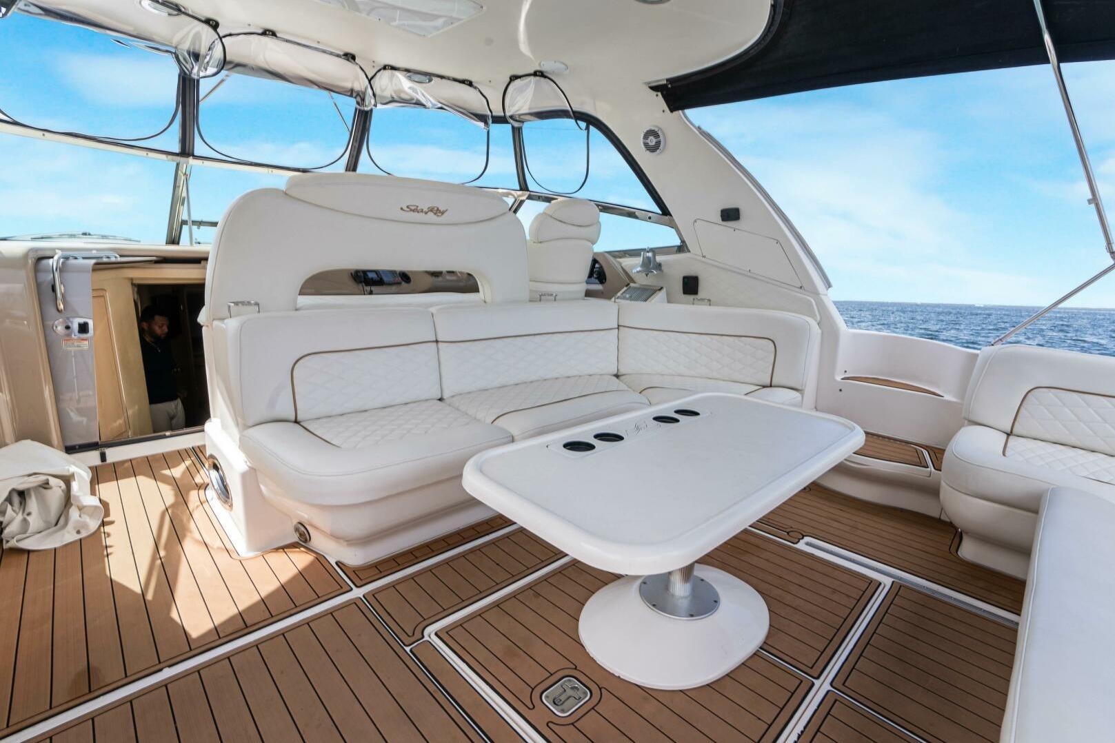 Luxurious 2003 Sea Ray Sundancer 460 yacht interior with white seating and ocean view.