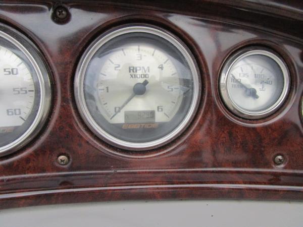 Dashboard gauges of a 2004 Ebbtide 22 Mystique boat.
