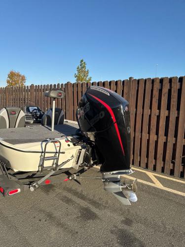 2025 Ranger ALPHA 208 boat with powerful outboard motor, parked outdoors.