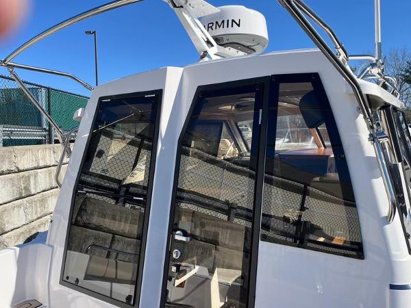 2025 Cutwater C-248 C Coupe boat with Garmin equipment, docked outdoors.