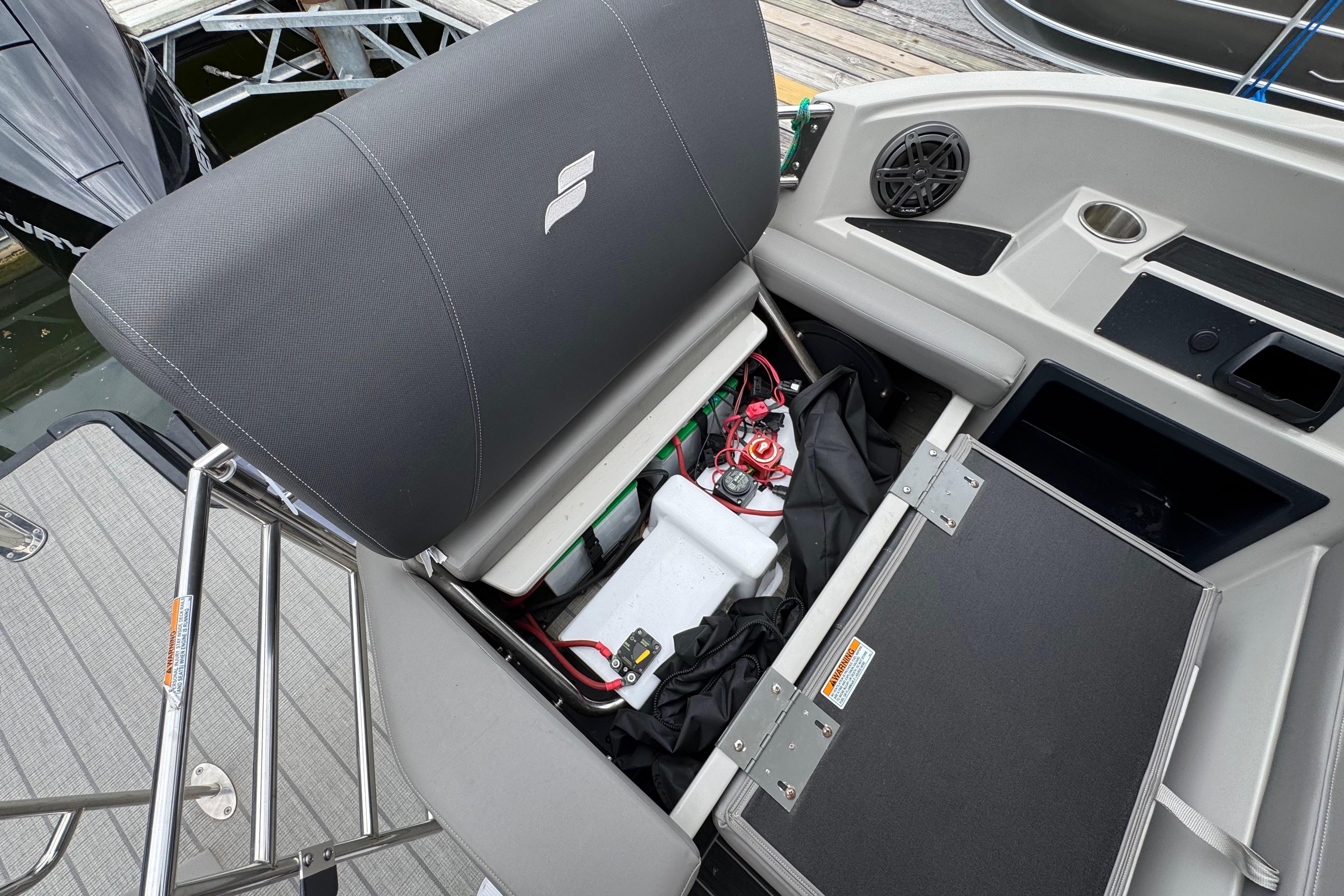 Starcraft MX 25 DL DH 2023 boat with open seat storage.