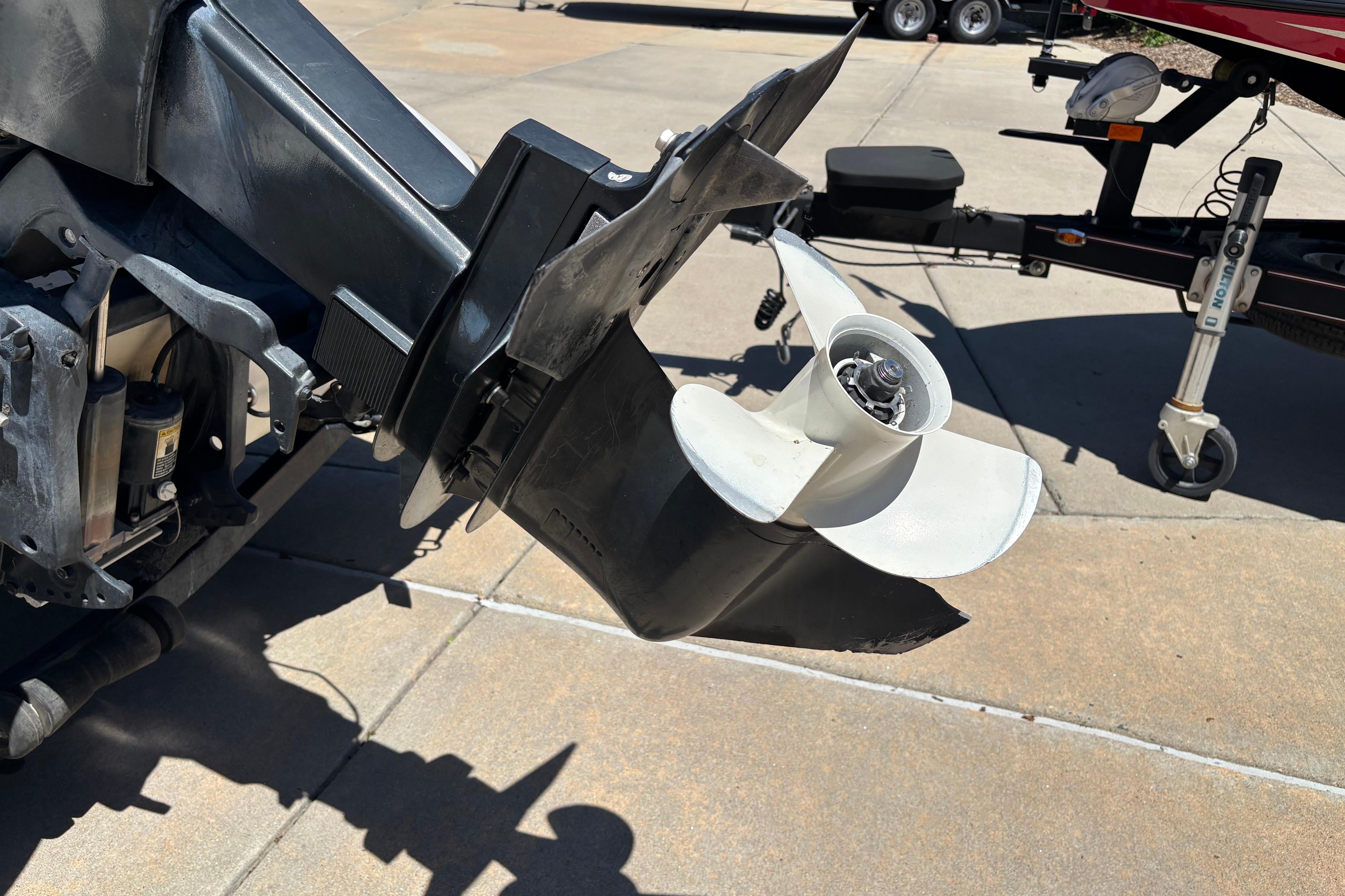 Outboard motor propeller of a 1998 Nitro 700 LX DC boat on a trailer.