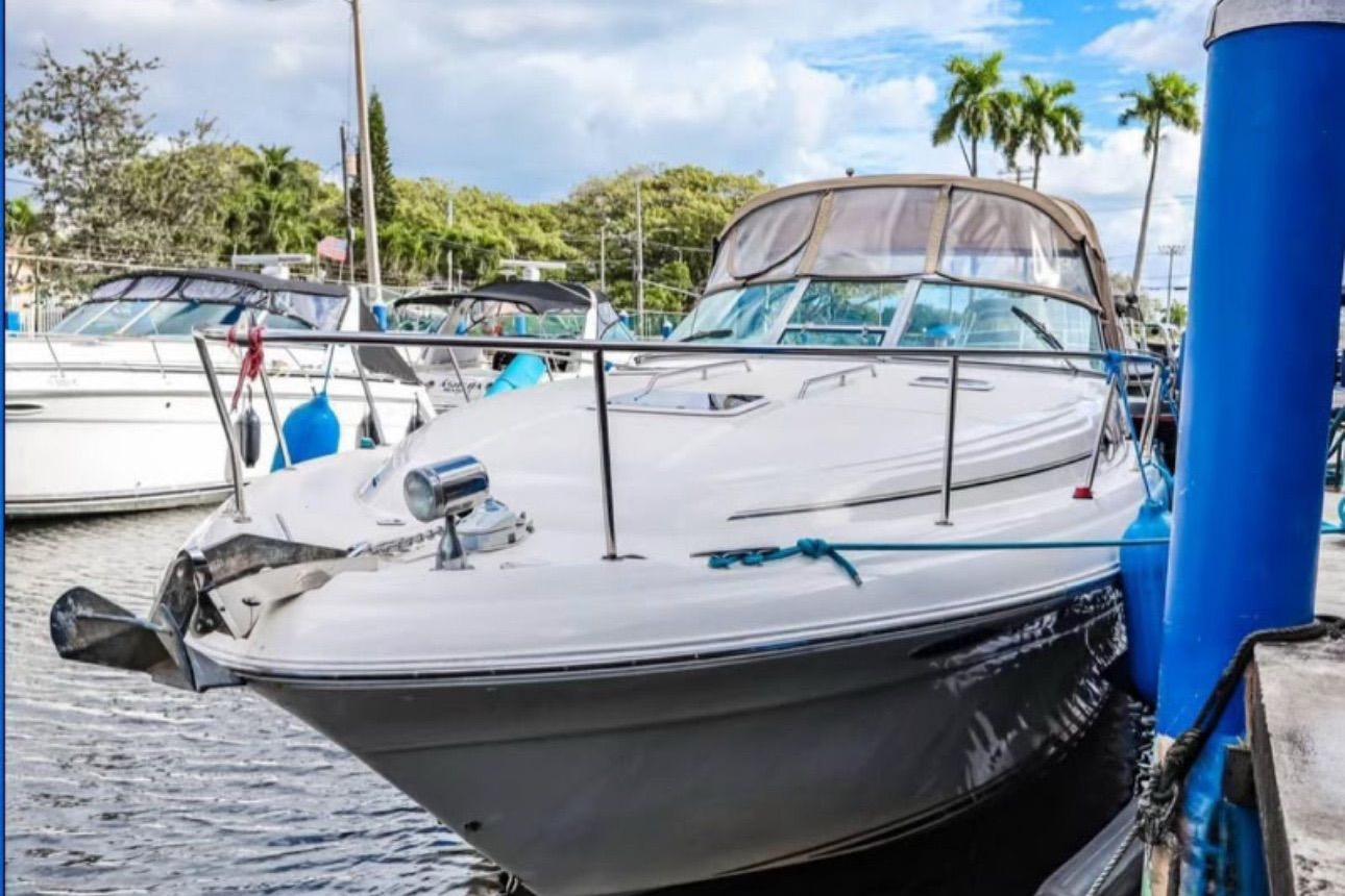 2000 Sea Ray 340 Sundancer docked at marina, surrounded by other boats.