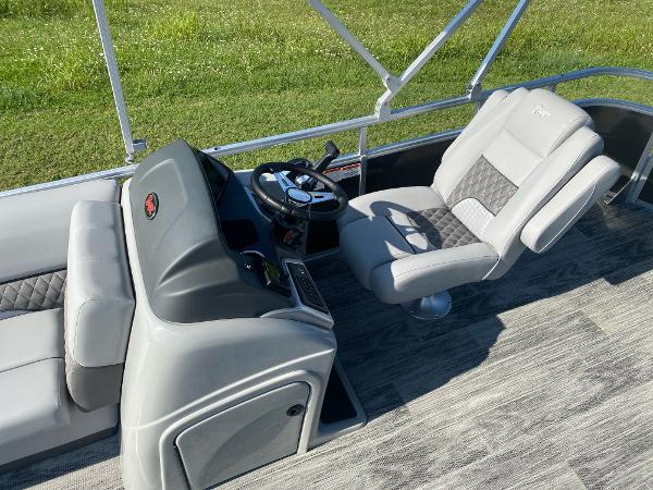 2024 Ranger Reata 223C boat interior with gray seating and steering console.