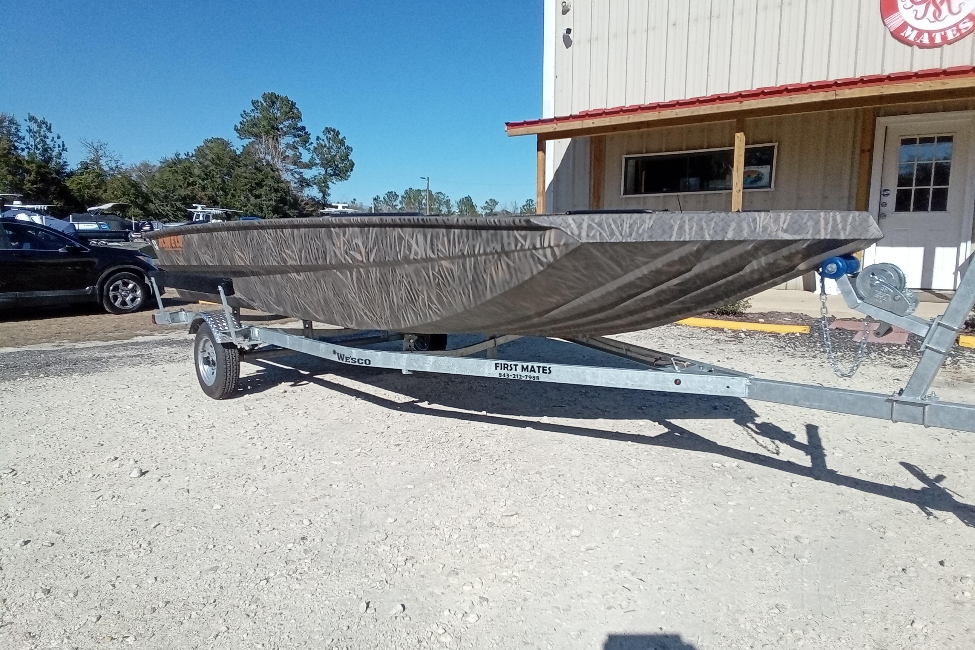 2026 Alweld 1756 Invader boat on trailer, parked outside a building.