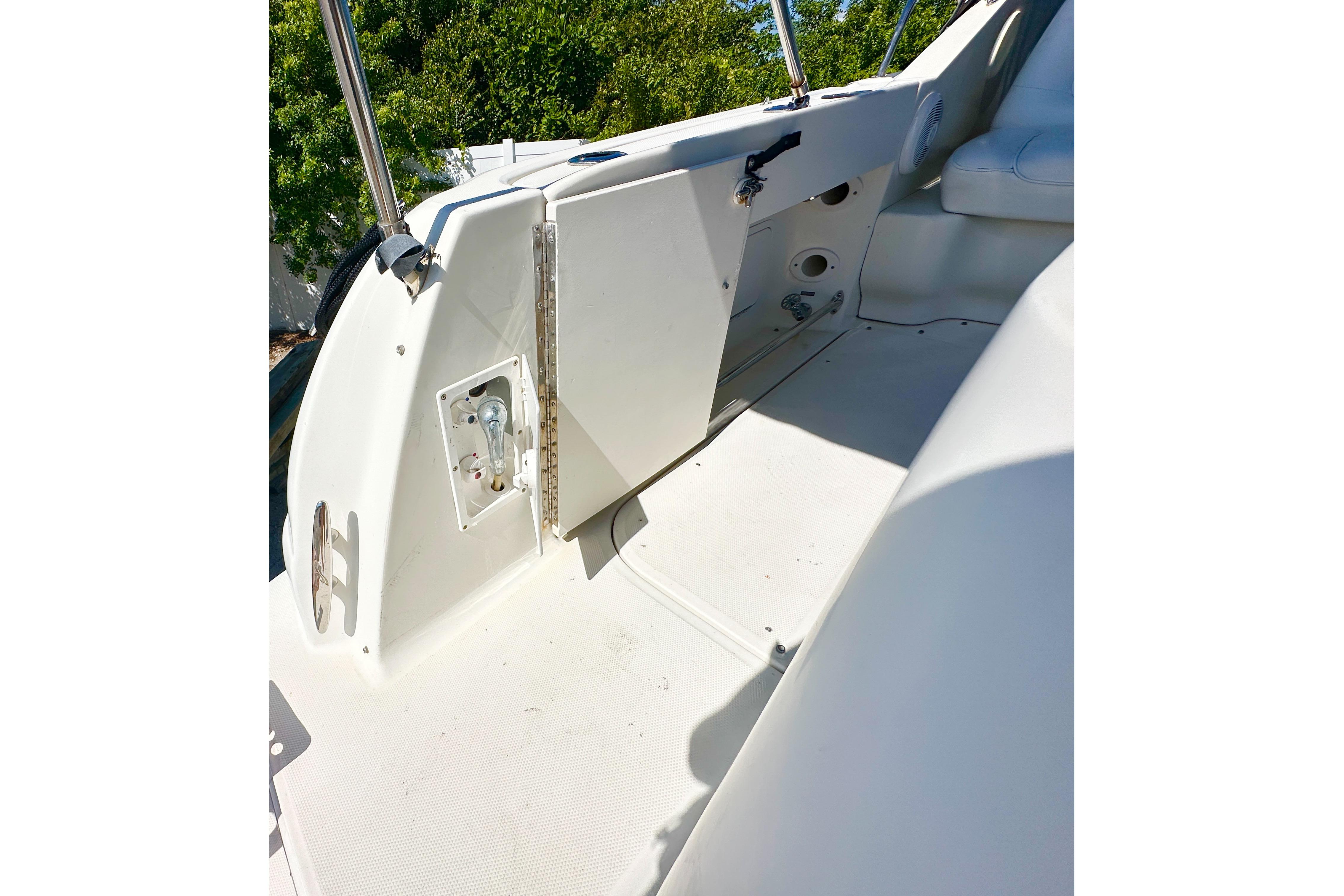 2006 Sea Ray 290 Amberjack boat interior with white seating and control panel.