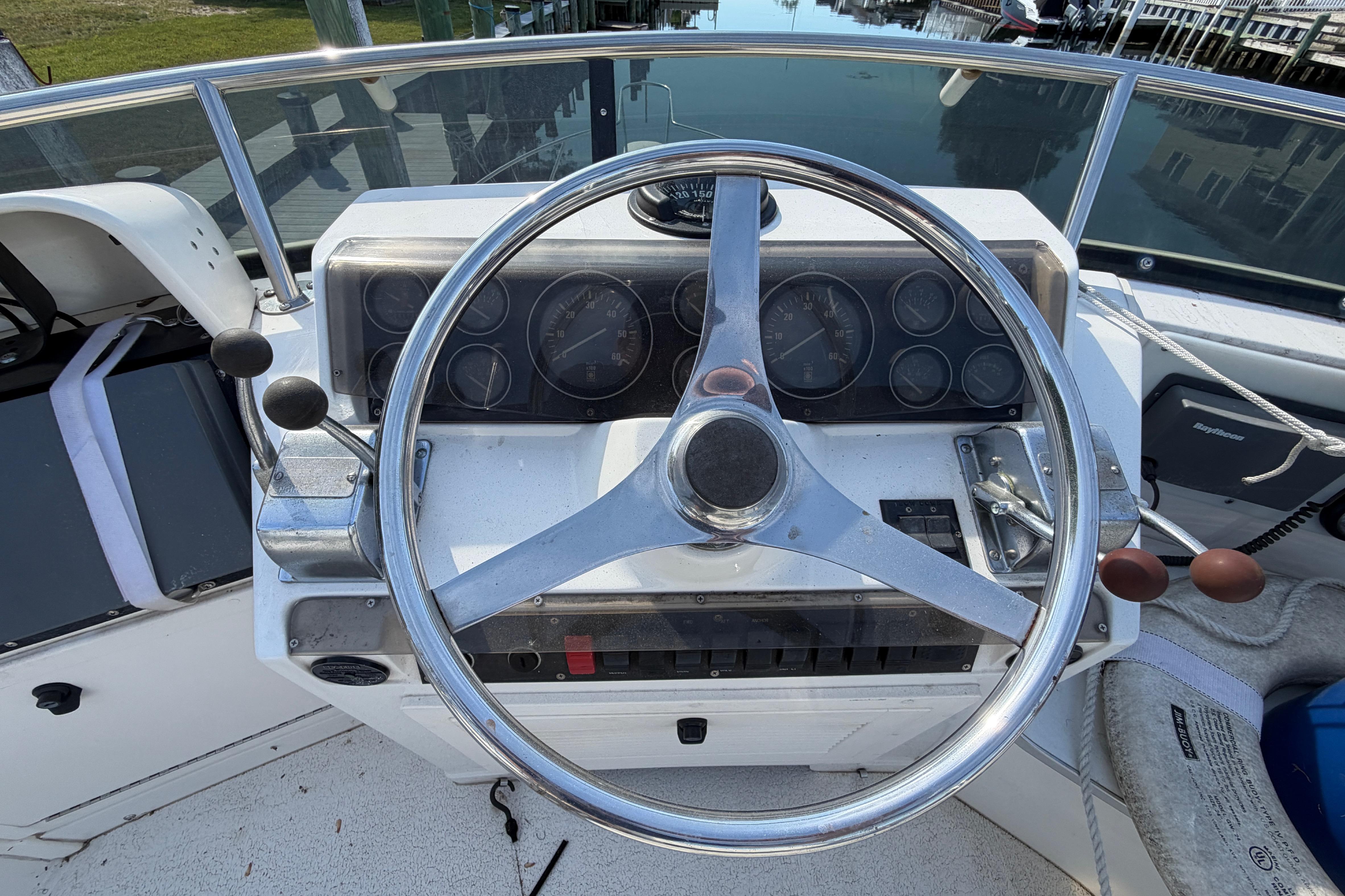 Steering wheel and dashboard of a 1995 Blackfin 29 Flybridge boat.