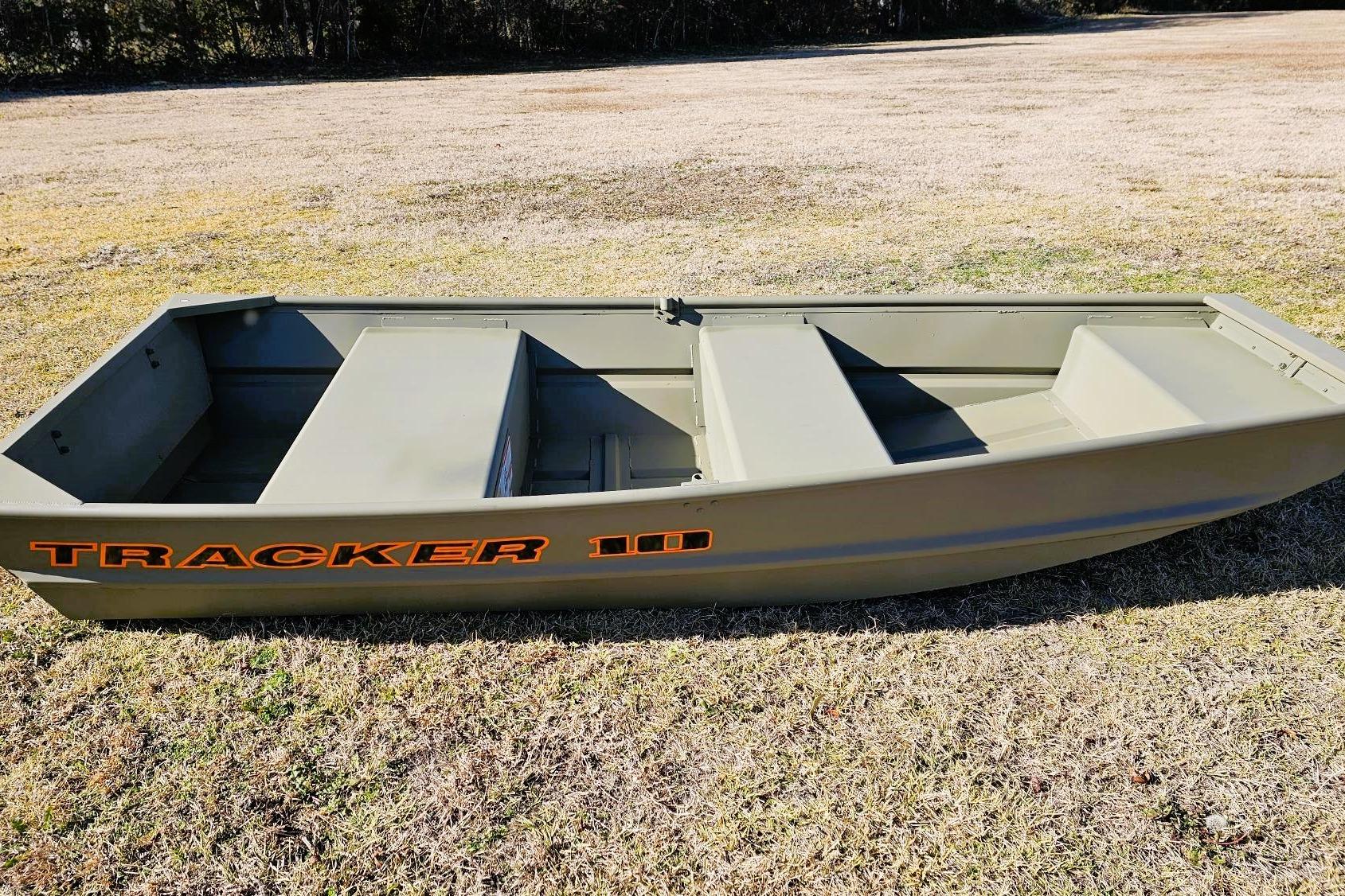 2026 Tracker Grizzly 10 Jon boat on grassy field, showcasing durable design and spacious interior.