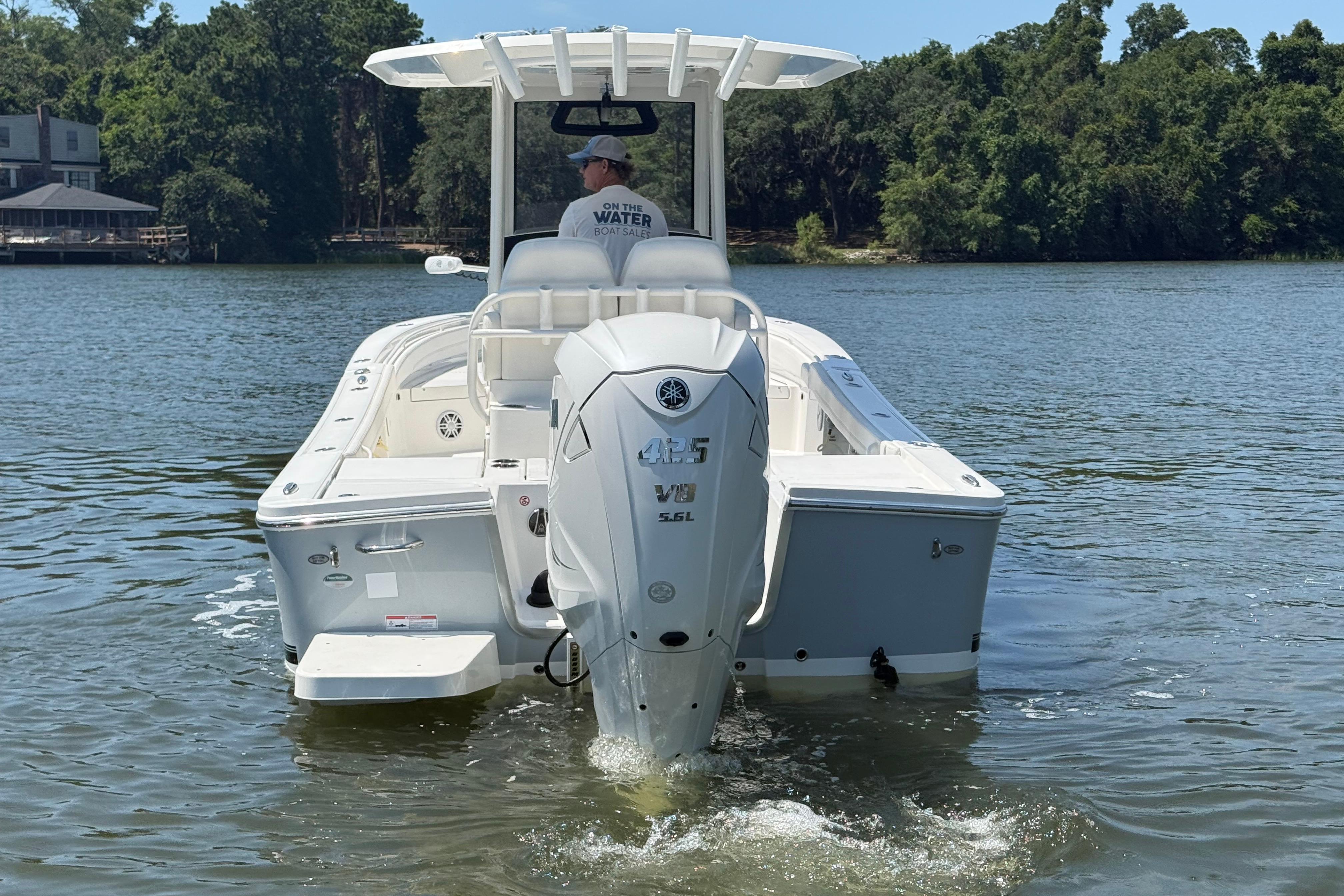 2023 Regulator 26XO boat on water, rear view with outboard motor.
