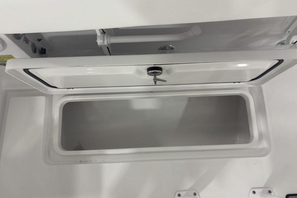 Open storage compartment on 2026 Sportsman Open 252 Center Console boat.