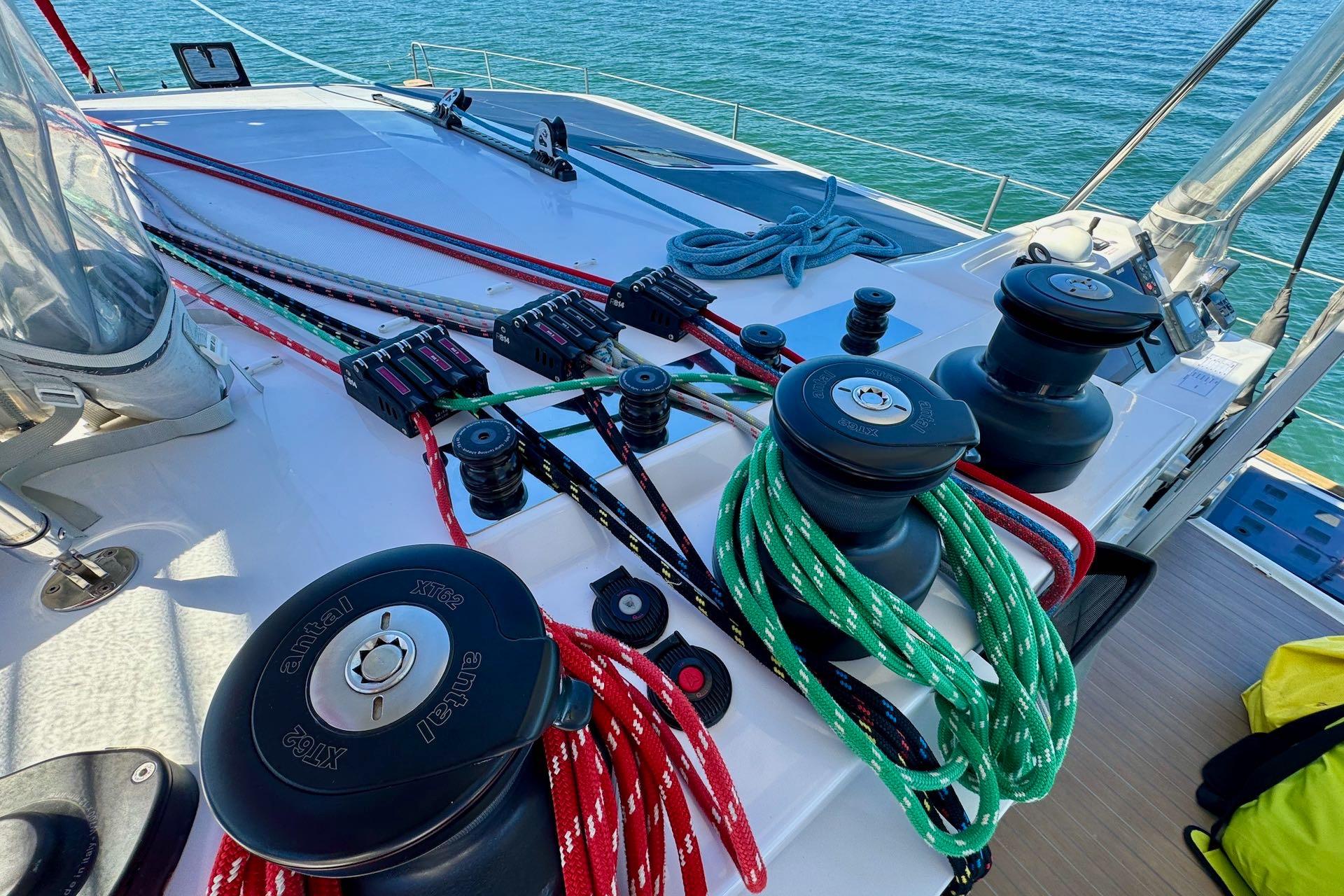 Deck of 2023 NEEL 52 trimaran with winches and colorful ropes.