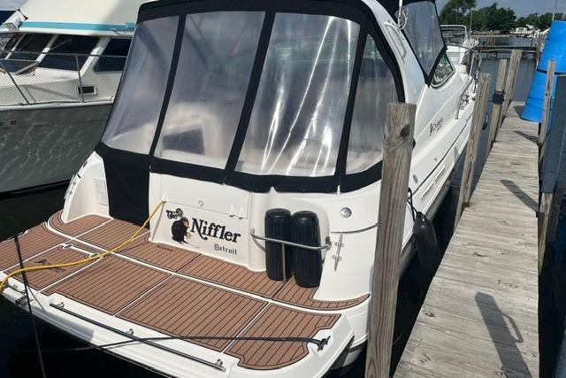 2004 Cruisers Yachts 3372 Express docked, featuring a sleek design and spacious deck.