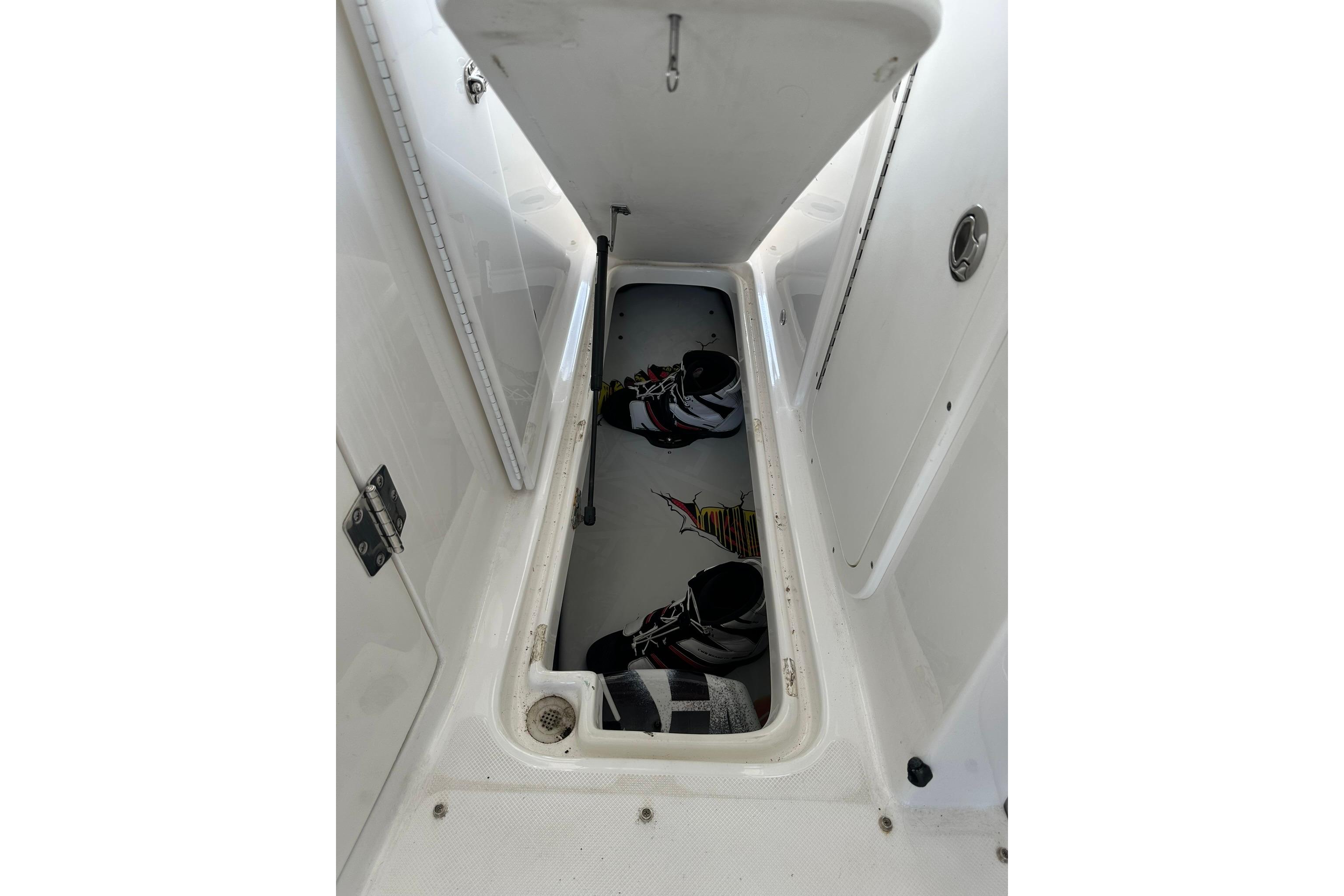 2013 Rinker 276 Captiva Bowrider storage compartment with wakeboard equipment.