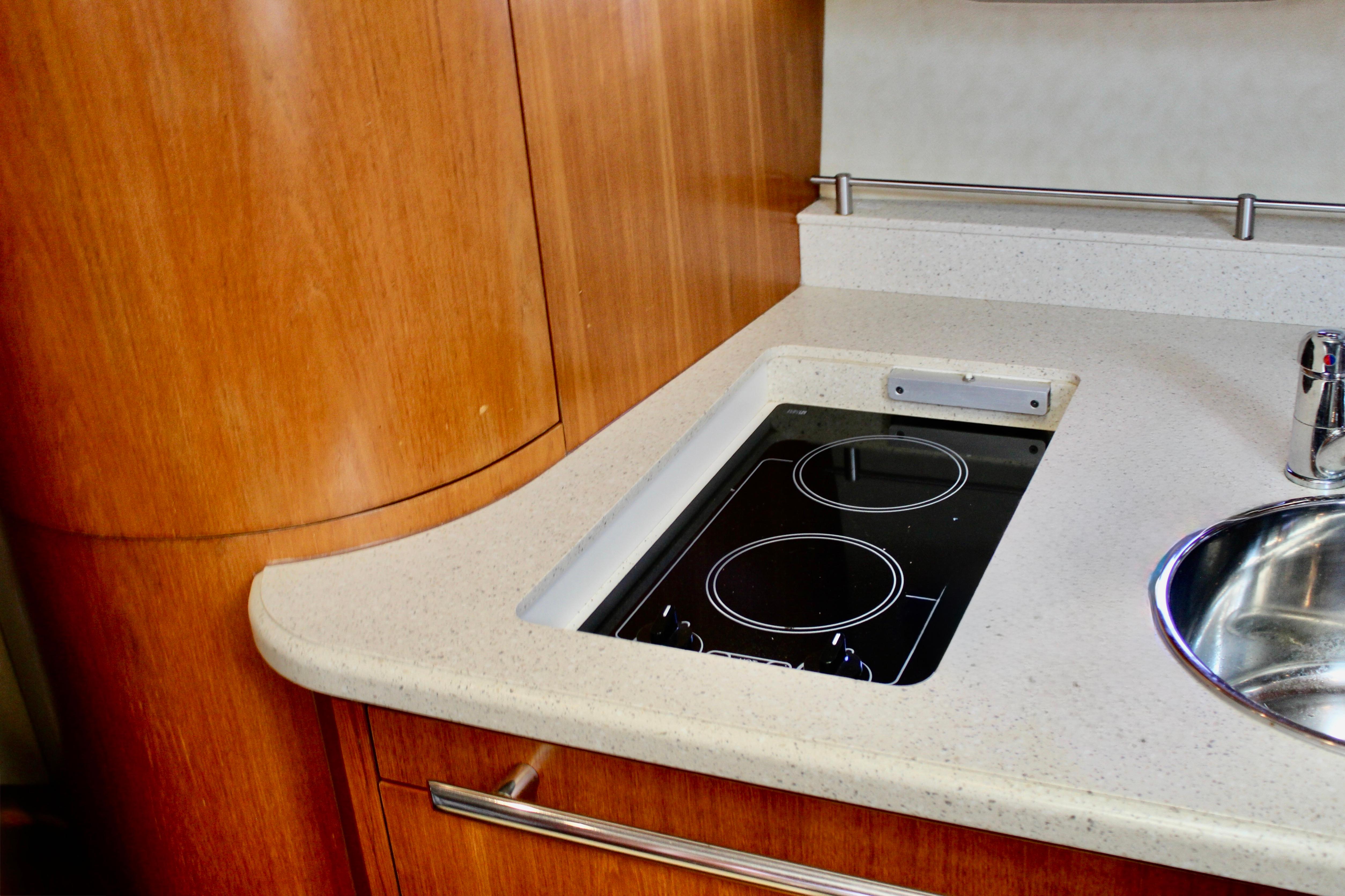 2008 Tiara Yachts 3500 Sovran kitchen with sleek cooktop and modern sink.