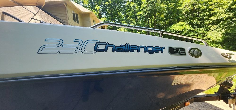2007 Sea-Doo Sport Boat 230 Challenger SE, on land with trees in the background.