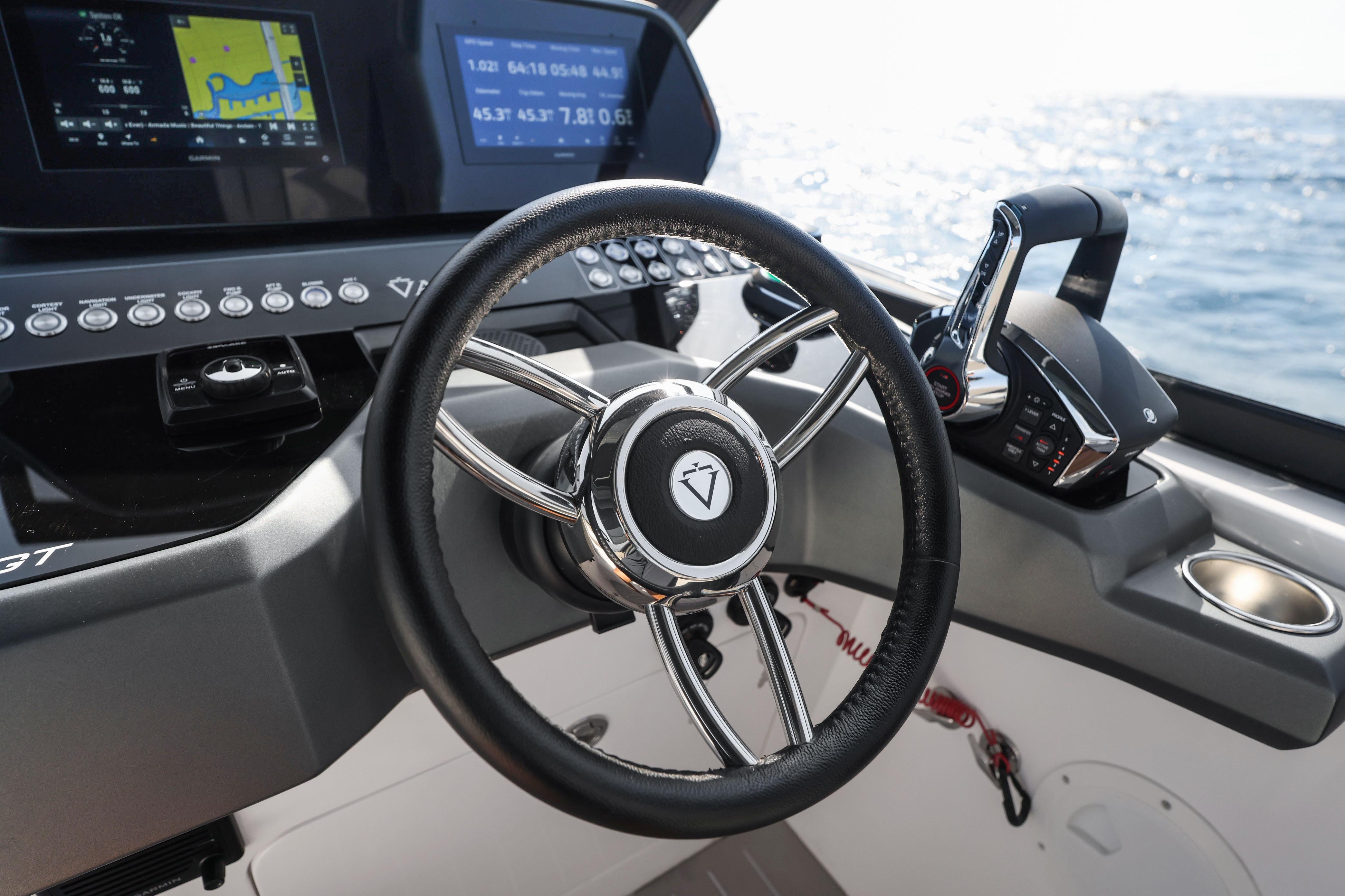 Steering wheel and controls of 2025 Valiatt 350GT boat, with ocean view.