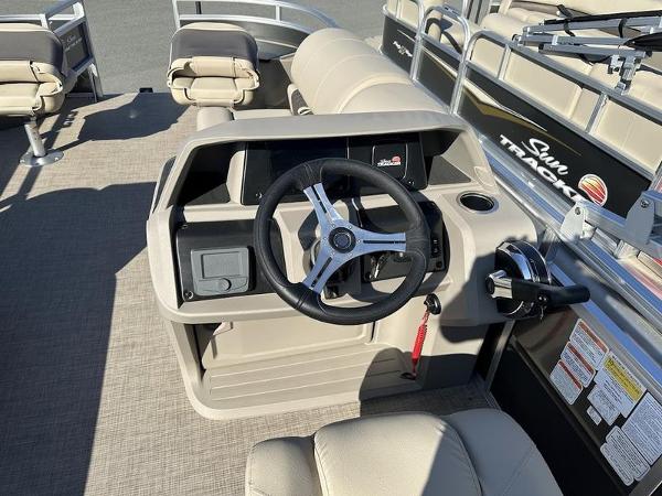 2025 Sun Tracker FB 20 DLX boat interior with steering wheel and seating.