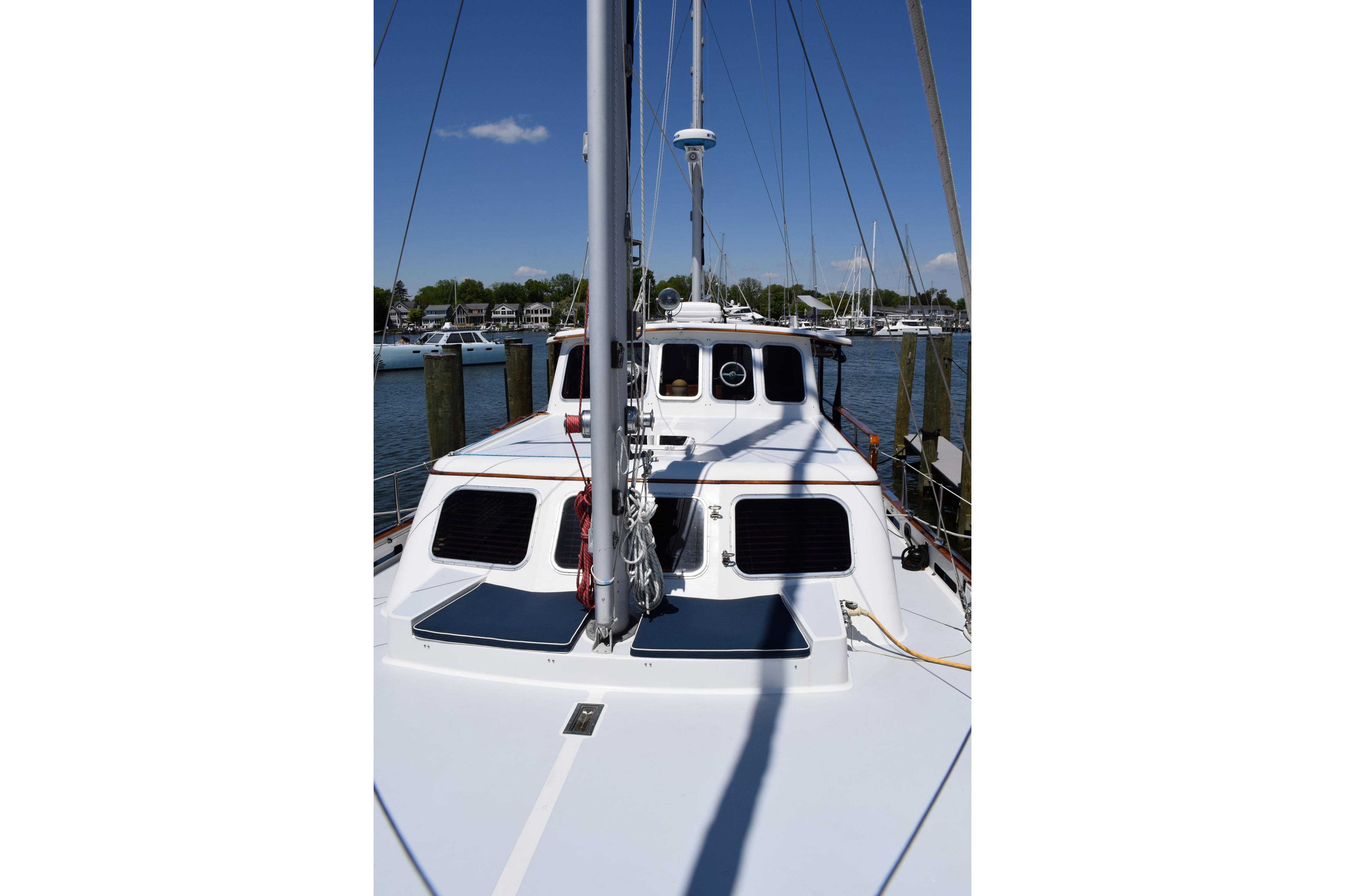 1980 Cheoy Lee 52 Motorsailer docked, showcasing deck and cabin details.