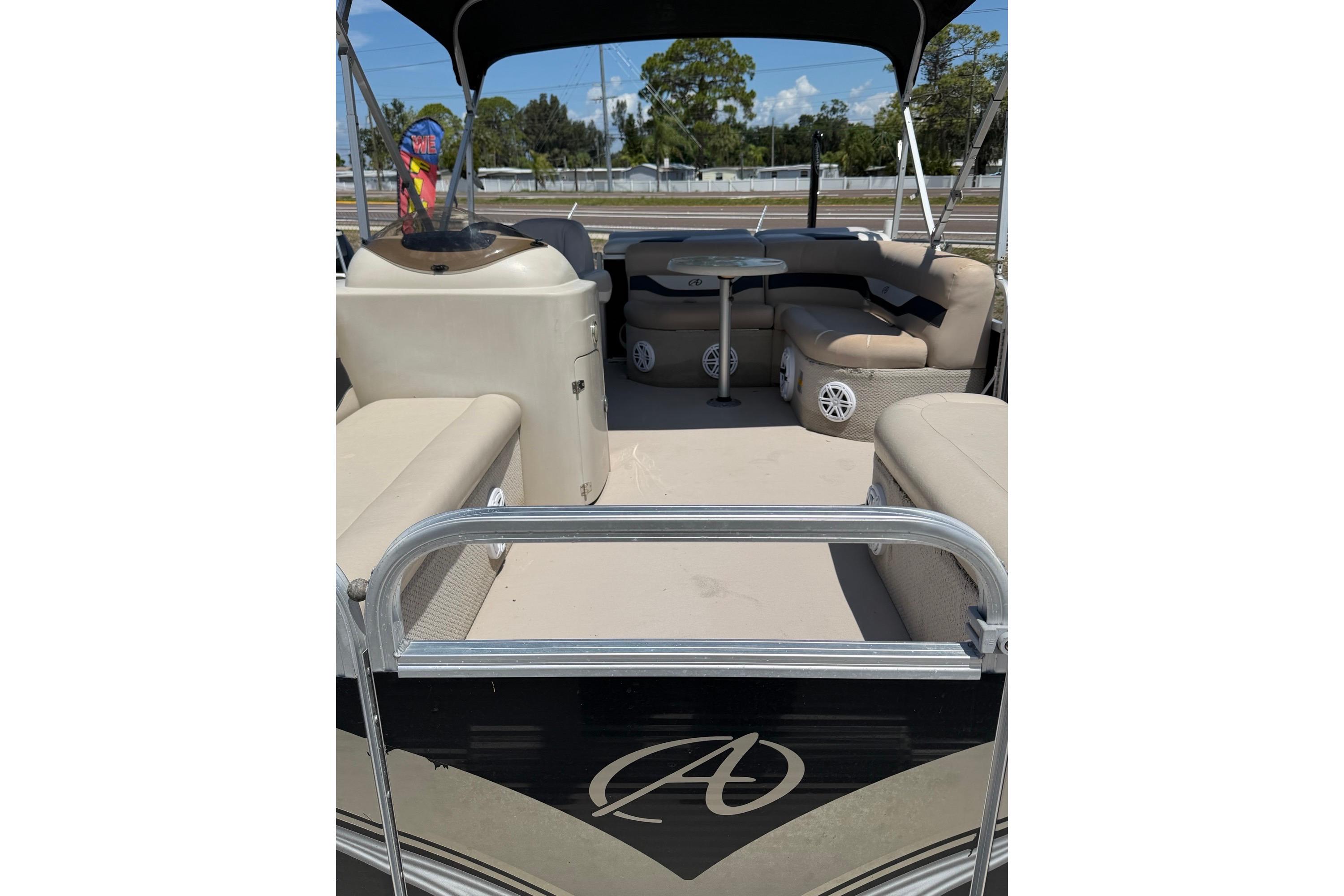 2014 Avalon 1900 pontoon boat interior with seating and table, under a canopy.