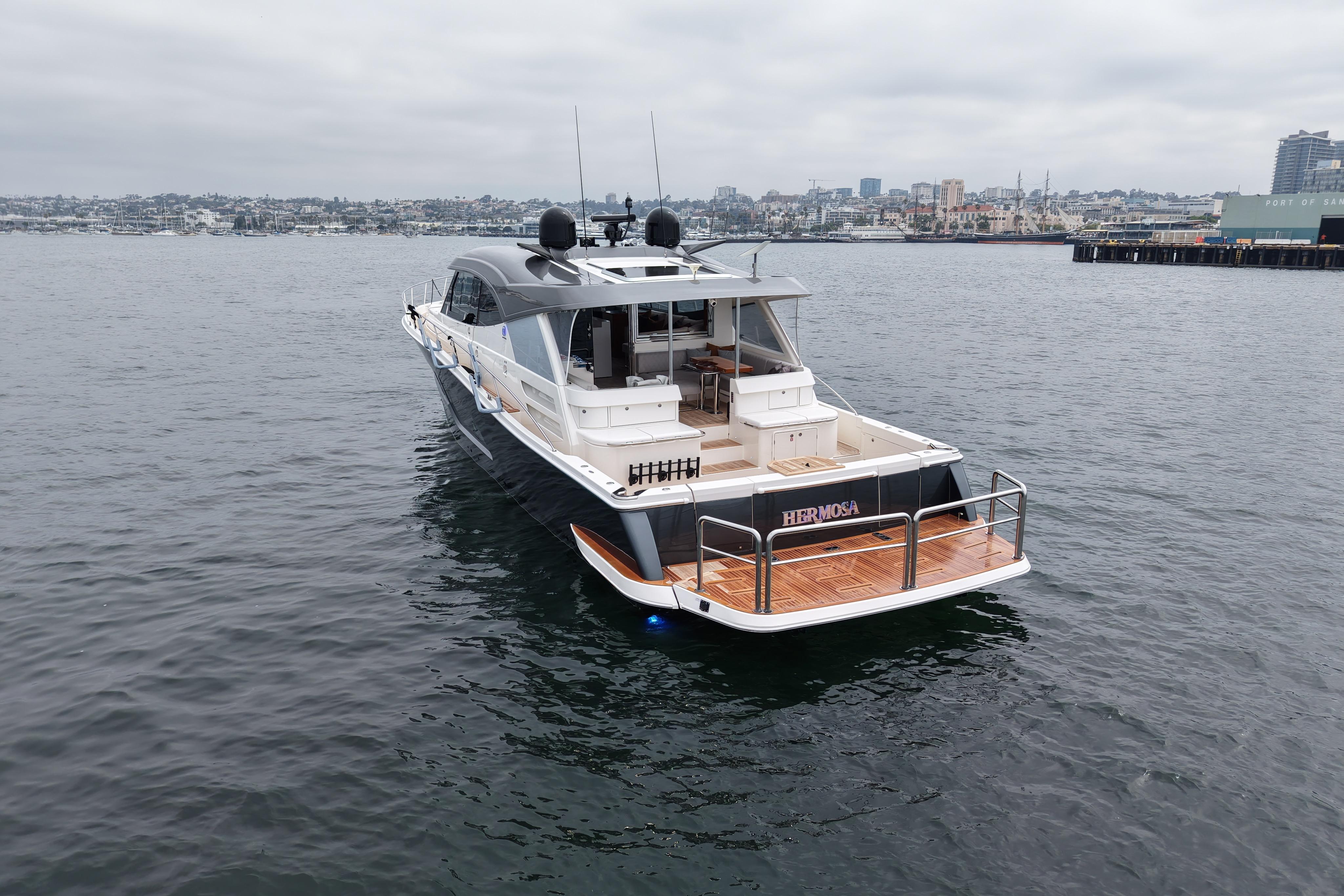 Luxury 2023 Riviera 645 SUV yacht on calm waters, showcasing sleek design and spacious deck.