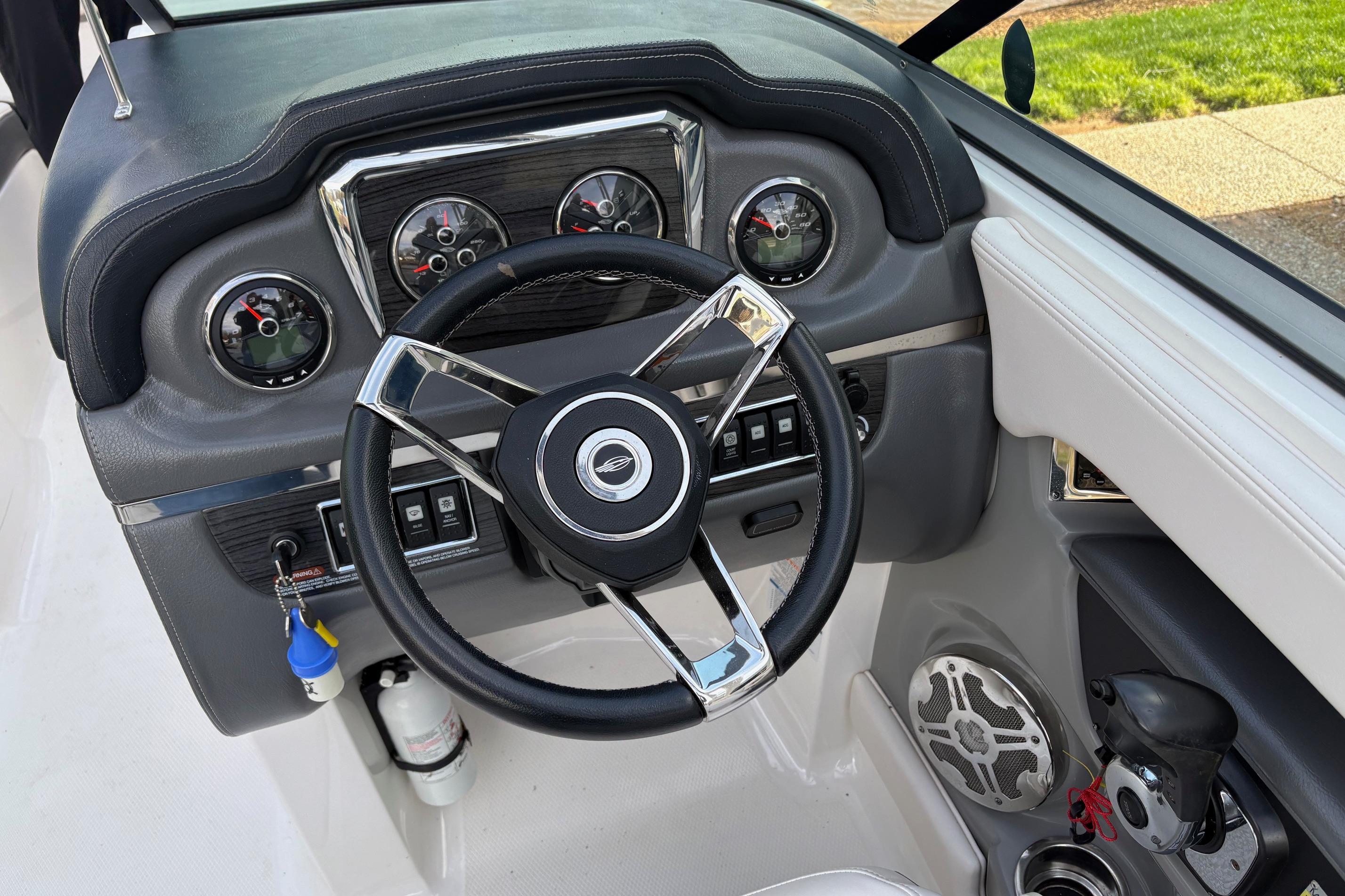 2016 Chaparral 246 SSi boat dashboard with steering wheel and gauges.