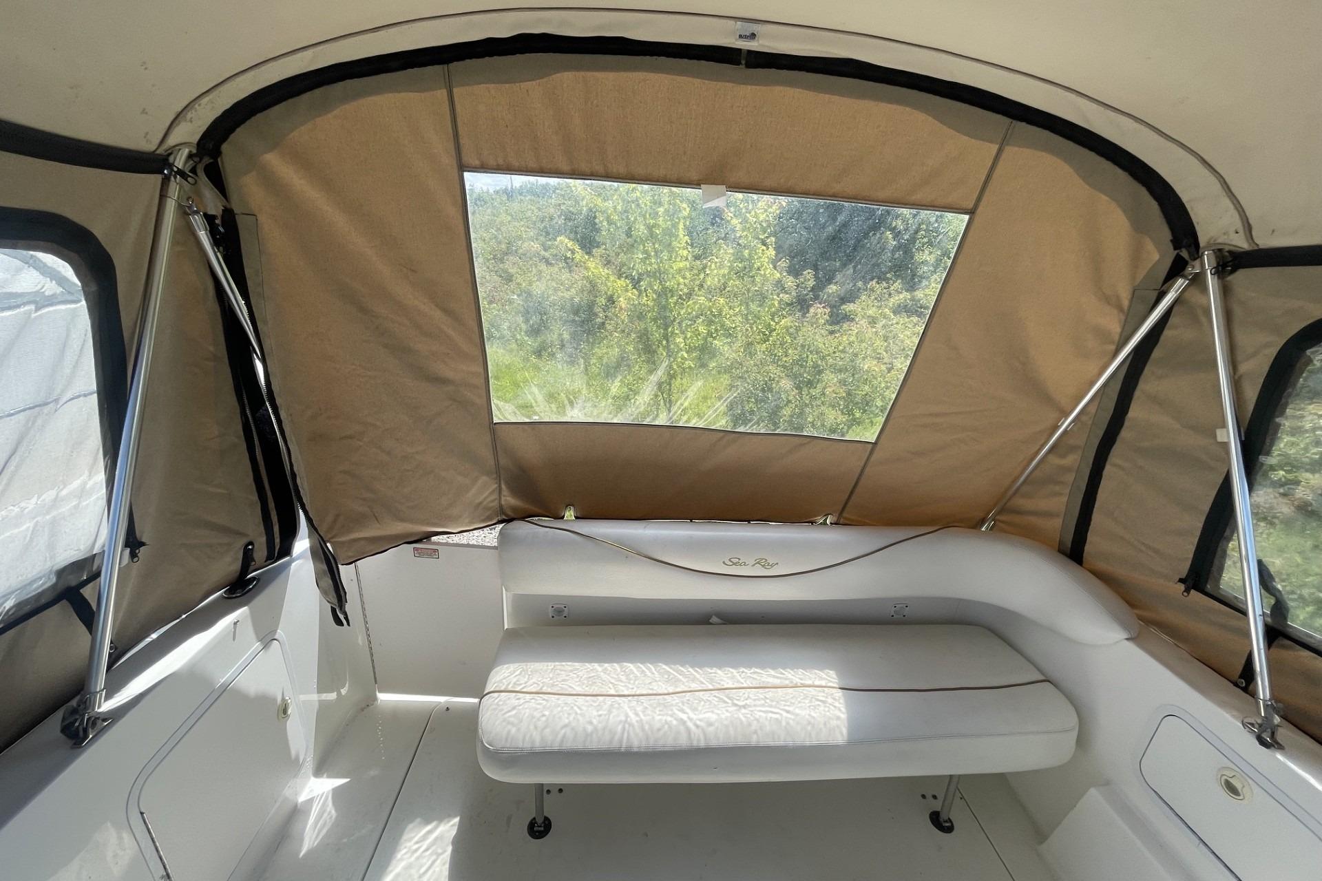 Interior view of 2000 Sea Ray Sundancer 260 boat with beige canopy and seating.
