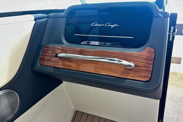 Interior of 2025 Chris-Craft Sportster 25, featuring elegant wood and chrome accents.
