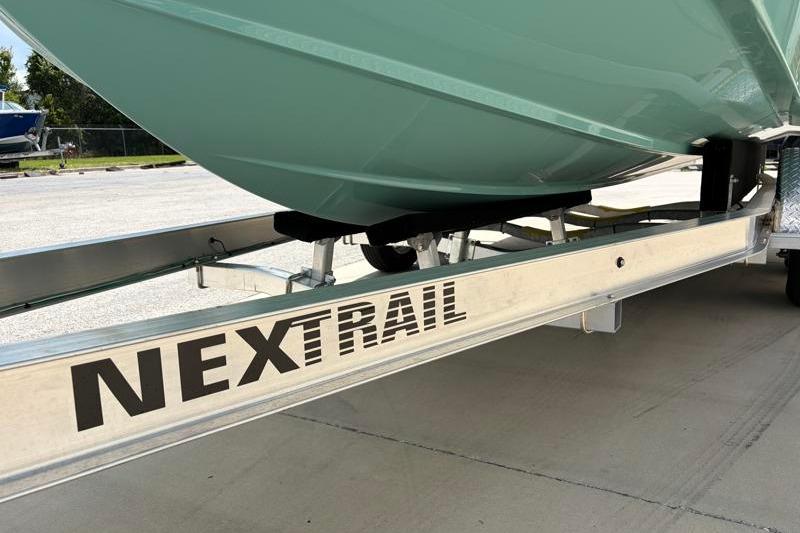 Trailer supporting a 2026 Hurricane SunDeck Sport 2050 OB boat, labeled "NEXTRAIL."