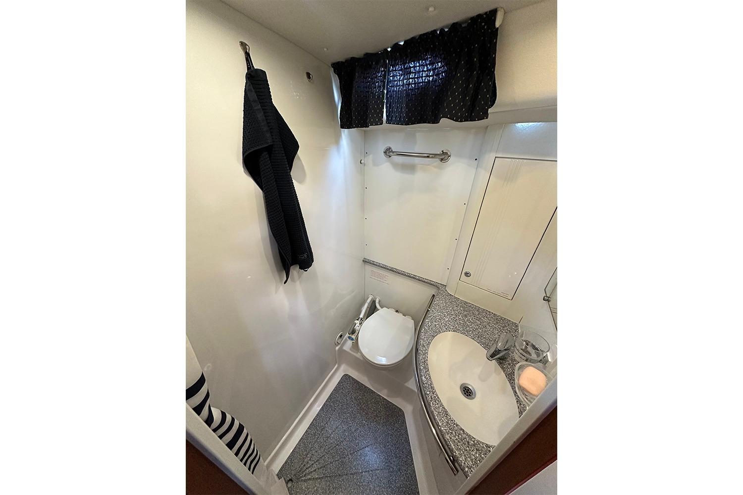 Bathroom interior of 2004 Najad 460 yacht, featuring compact design and modern fixtures.