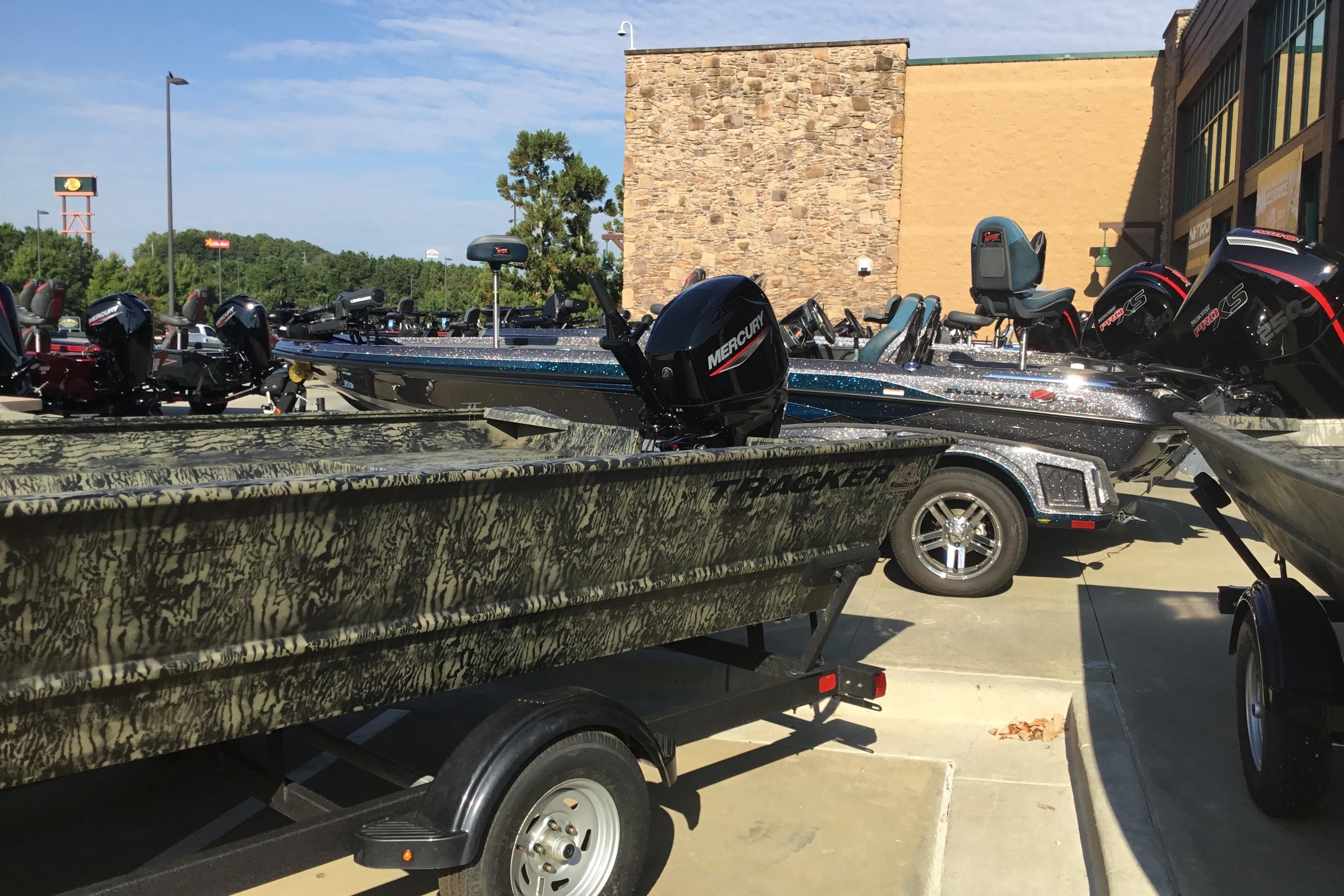 2025 Tracker Grizzly 2072 Utility boat displayed outdoors with Mercury engines.