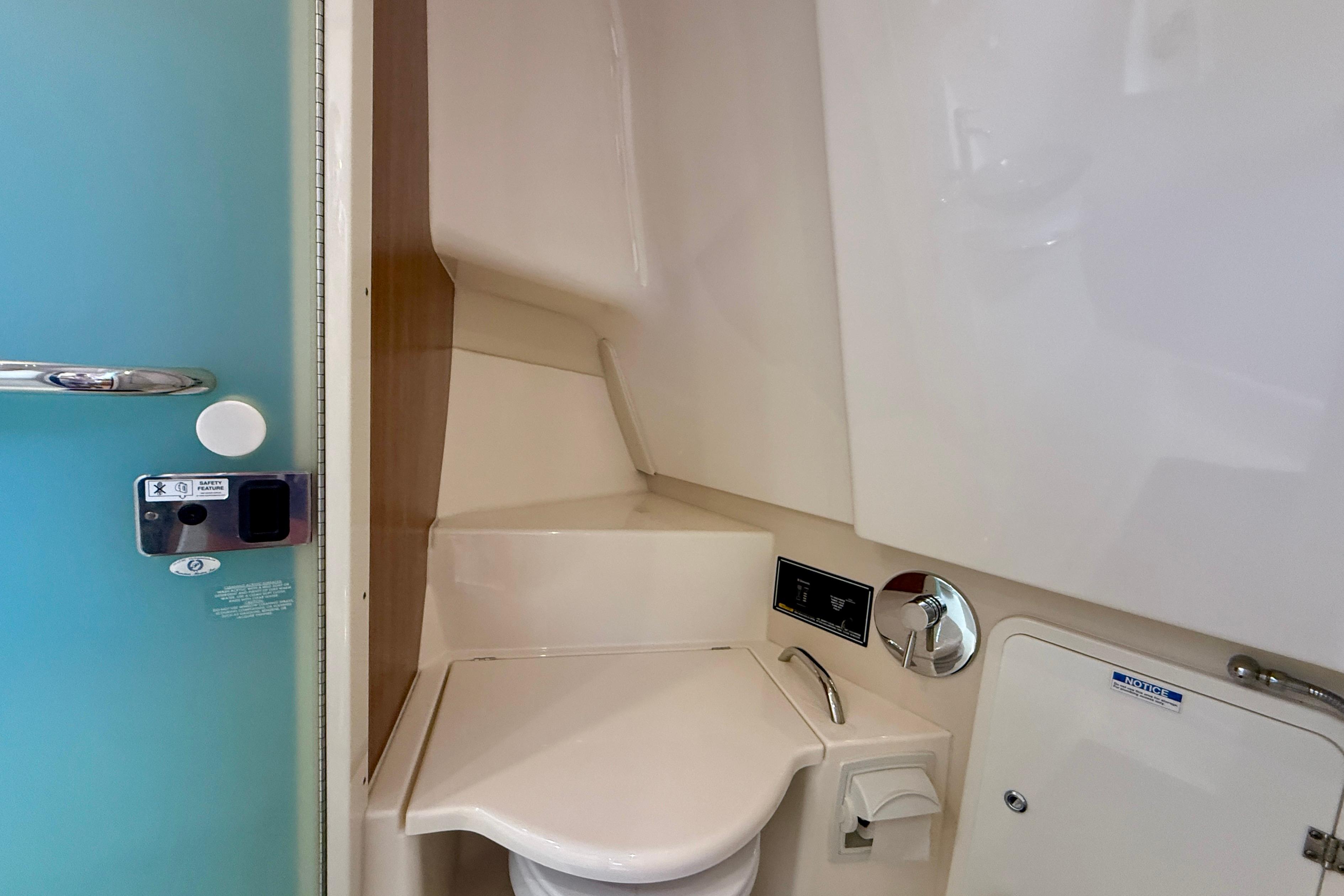 Interior of 2012 Pursuit OS 345 Offshore boat bathroom with modern fixtures.