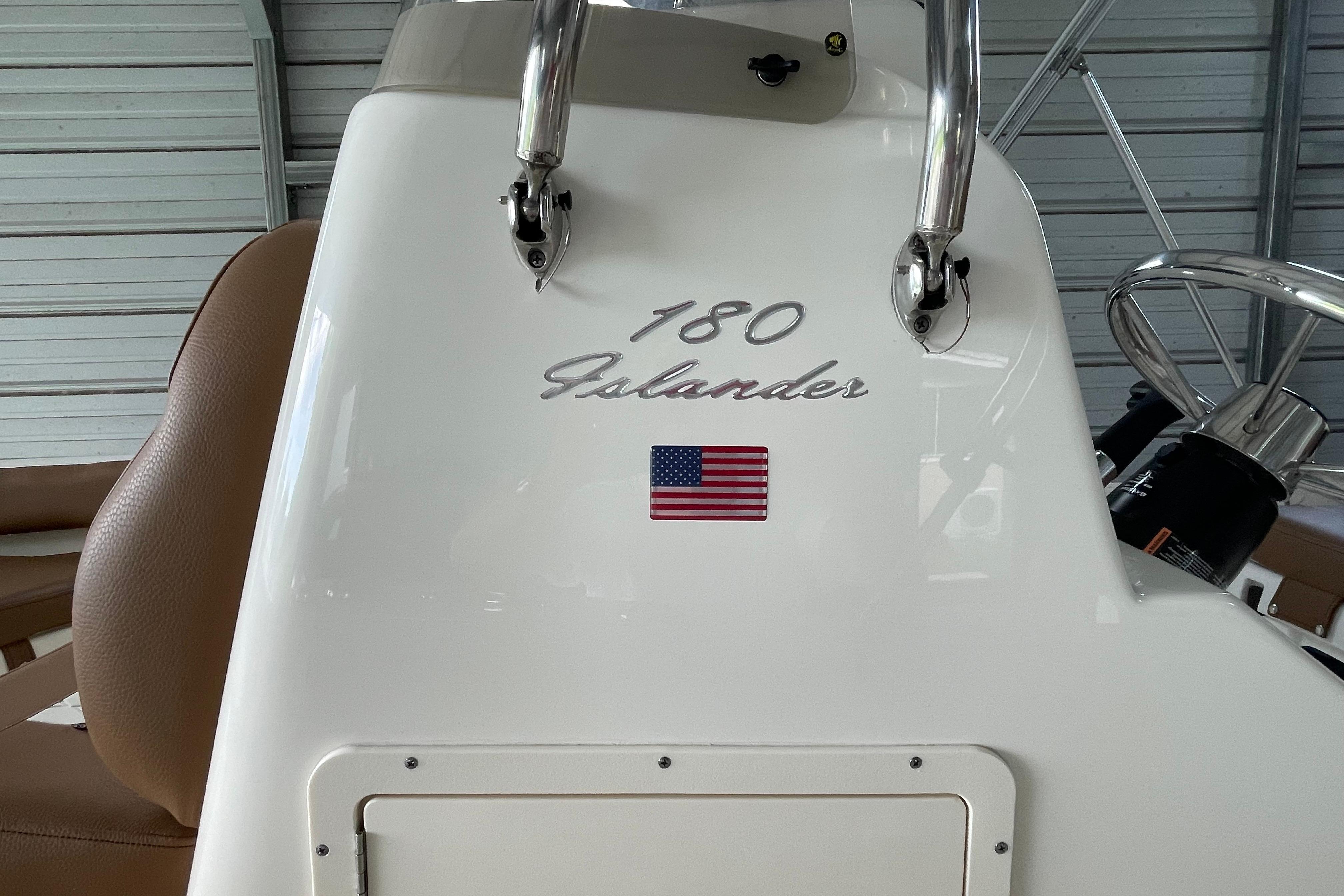 2024 Pioneer 180 Islander boat console with American flag emblem in a garage setting.