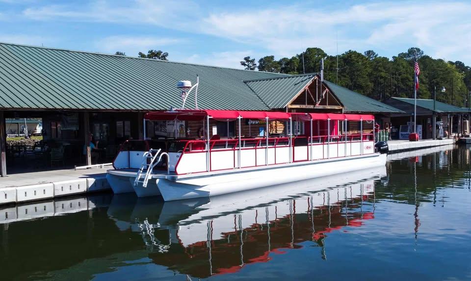 2024 Aloha Pontoon 50' Water Taxi docked at a marina with red canopy.