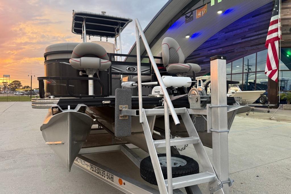2022 Apex Marine 8524 Pro Fish N Cruise pontoon boat on trailer at sunset.