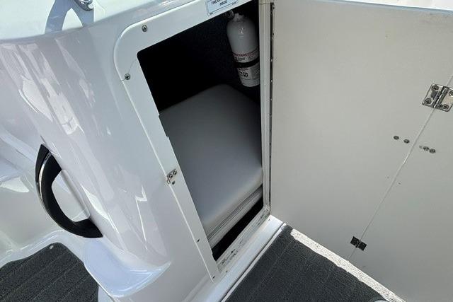 Storage compartment on a 2014 Yamaha Boats 212X, featuring a fire extinguisher.