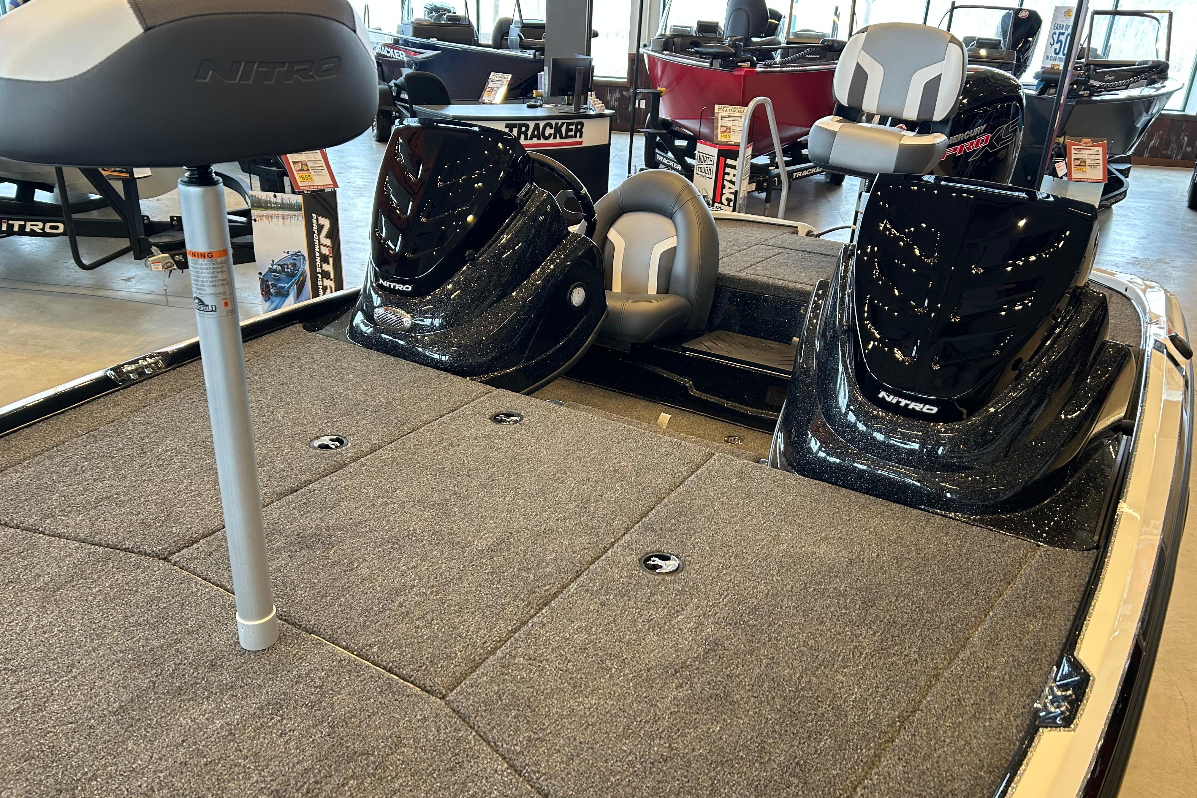 2026 Nitro Z17 boat interior with seating and storage compartments in showroom.