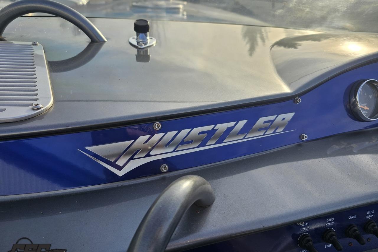 2007 Hustler 41 Razor dashboard with logo and control panel.