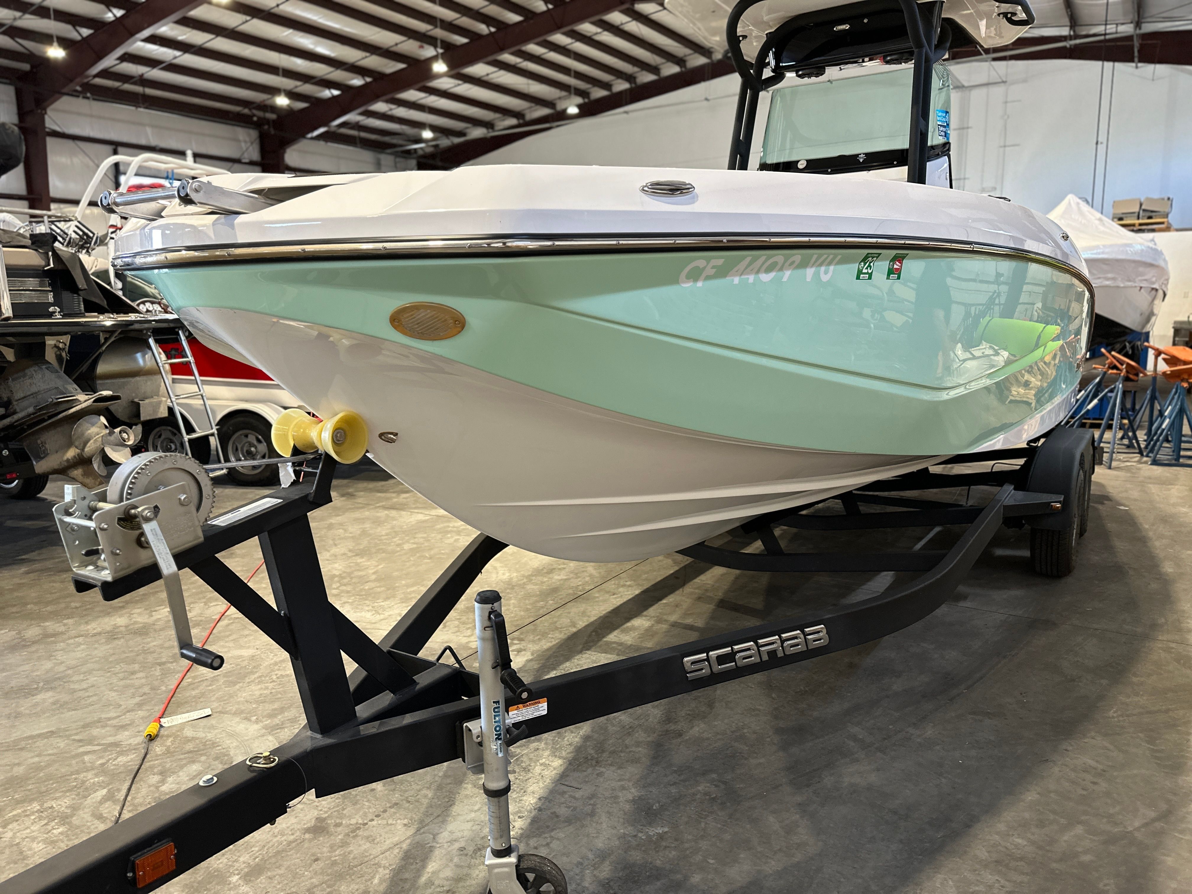 A 2021 Scarab 255 Open ID boat on a trailer in a warehouse.