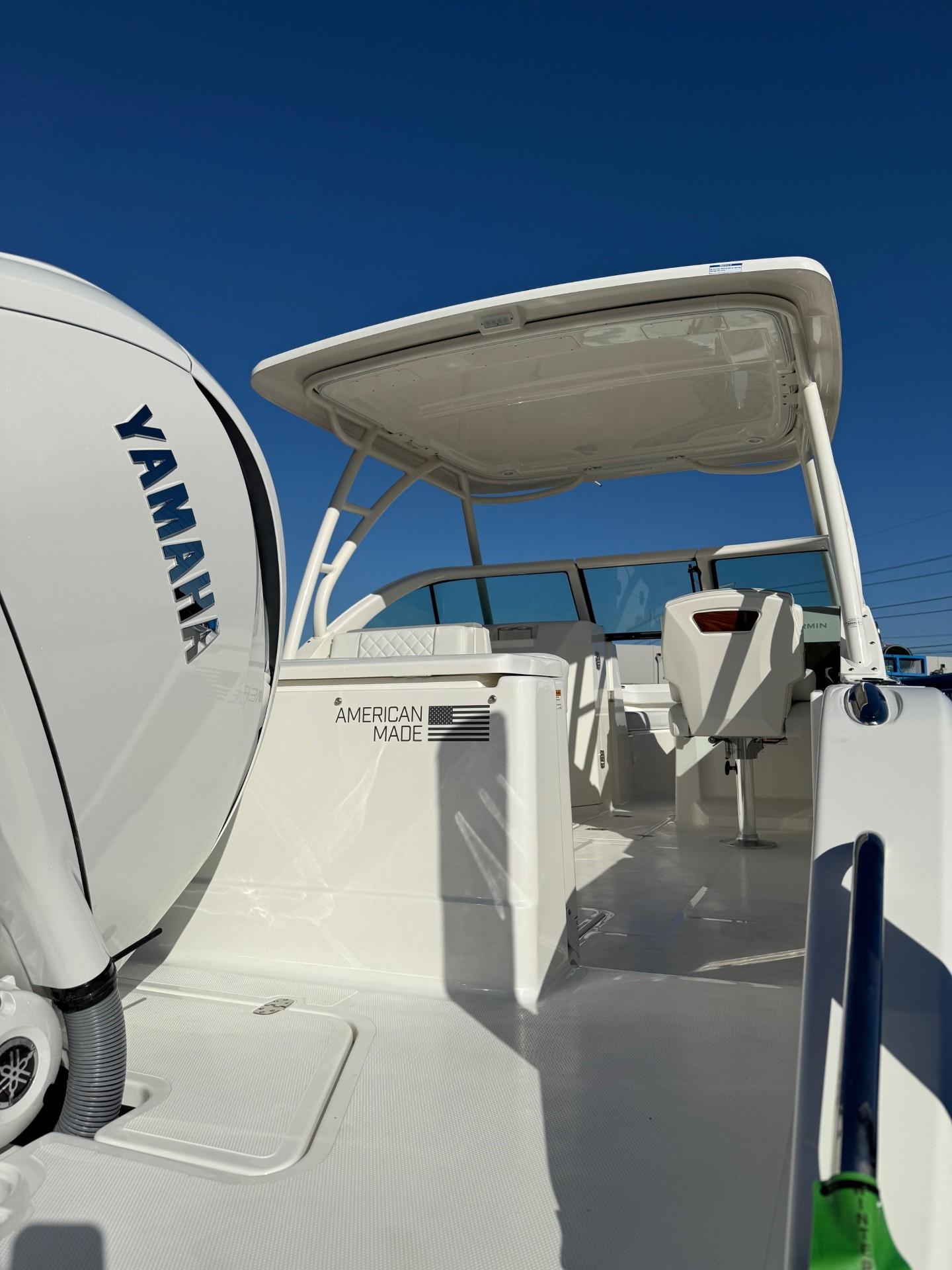 2025 Pursuit DC 246 Dual Console boat with Yamaha engine, showcasing sleek design and spacious deck.