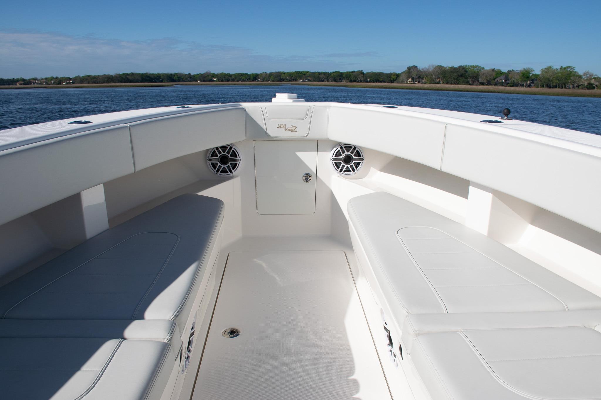2022 SeaVee 322Z boat interior with white seating and speakers, on calm water.