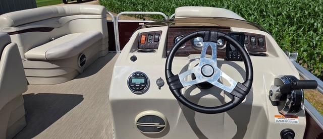 The image shows the cockpit of a 2018 Bennington 18SL with a sleek steering wheel.