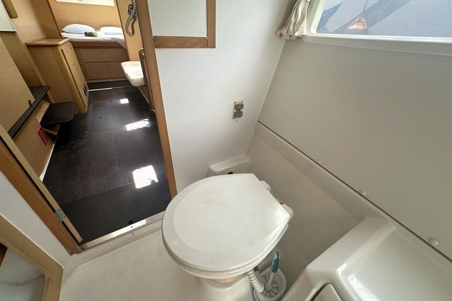 Interior of 2008 Lagoon 420 yacht showing bathroom and adjacent cabin area.